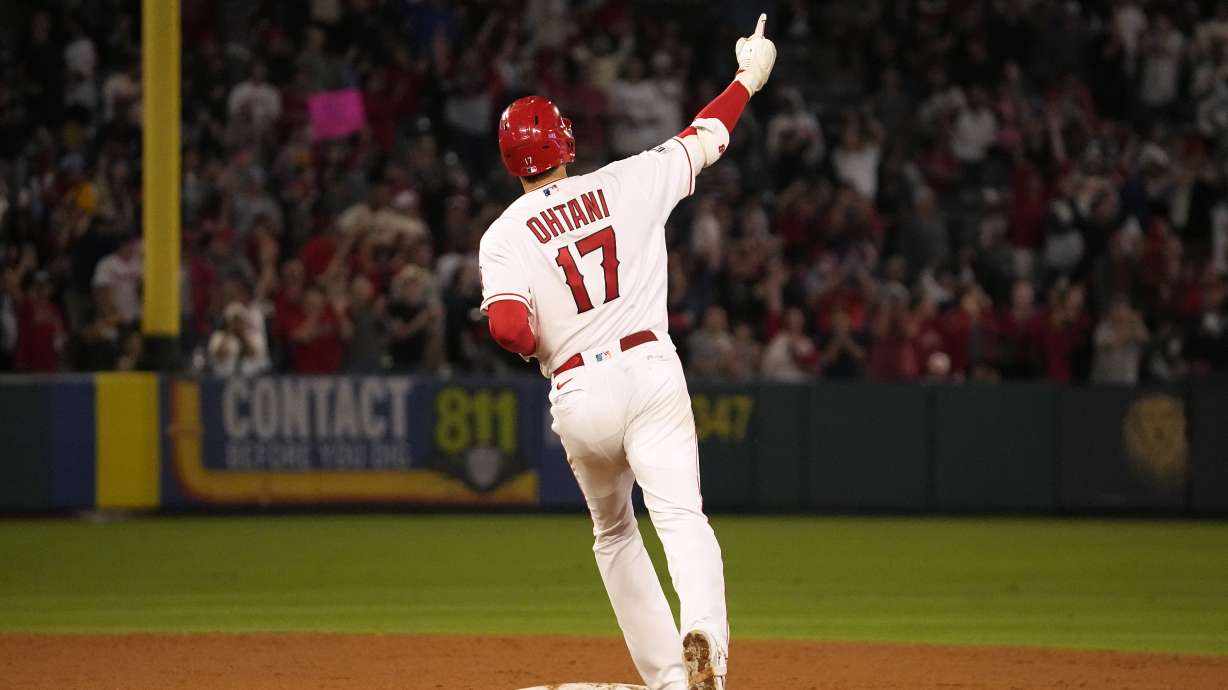 Los Angeles Angels' Shohei Ohtani celebrates as he rounds second after hitting a solo home run during the seventh inning of a baseball game against the Chicago White Sox Tuesday, June 27, 2023, in Anaheim, Calif.