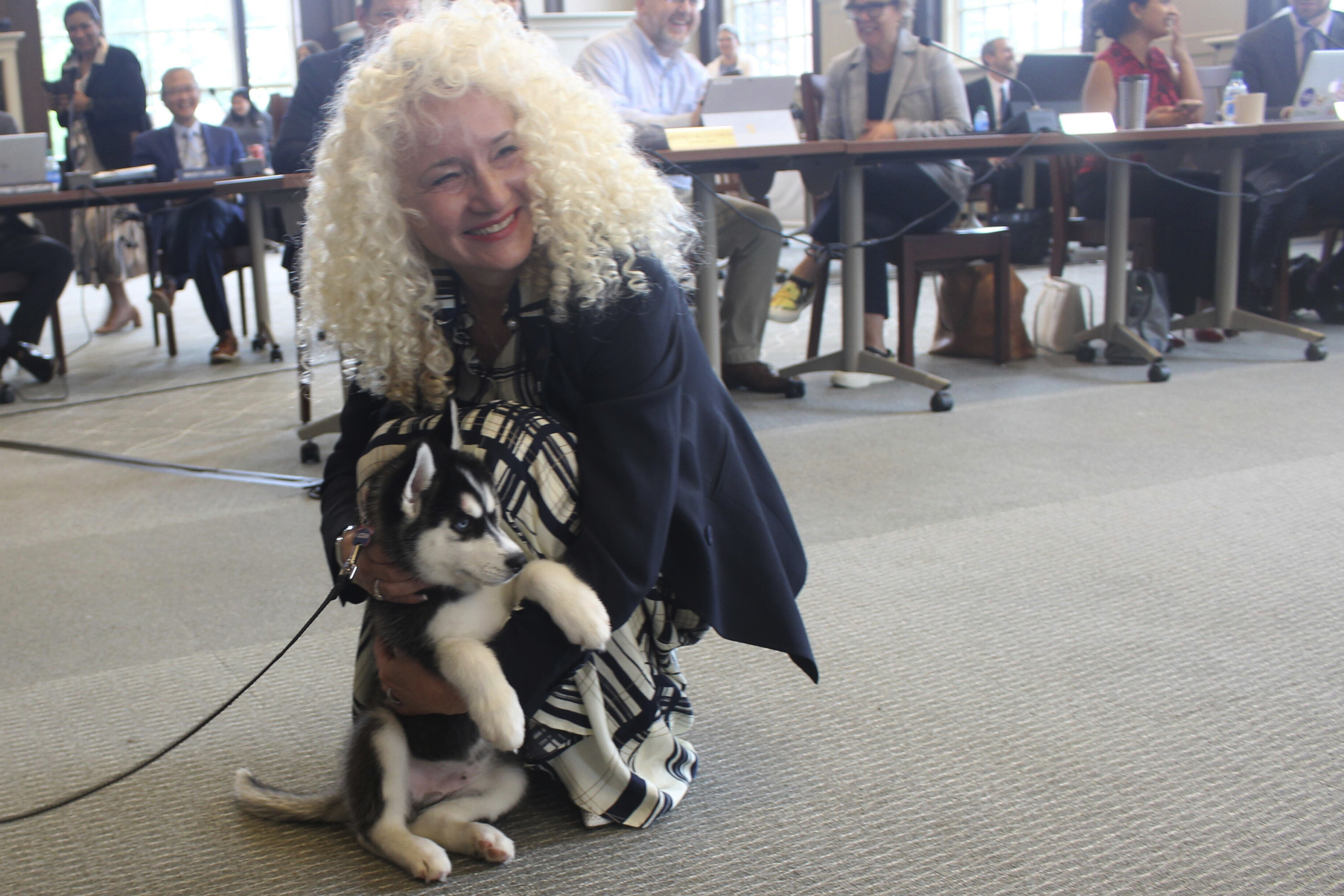 UConn president Radenka Maric holds the schools new mascot, Jonathan XV during a board of trustees meeting on Wednesday, June 28, 2023, in Storrs, Conn. The puppy is living with the same host family as UConn's current mascot, Jonathan XIV, and being trained for his new duties, which include appearing at sporting and other on-campus events and doing social media promotions.