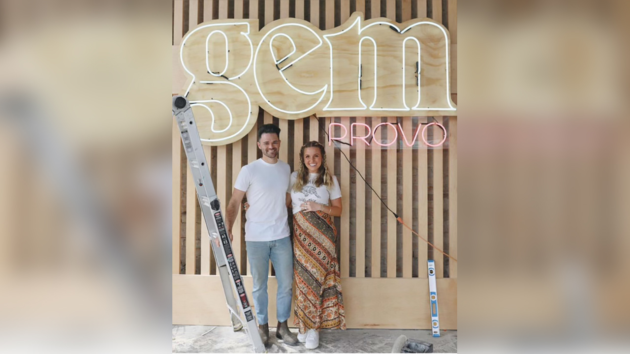 Gem Studio owner Matt James and his wife pose in front of their business, where customers can create high-quality rings. Experience-based businesses like the Gem Studio are becoming popular in Utah.