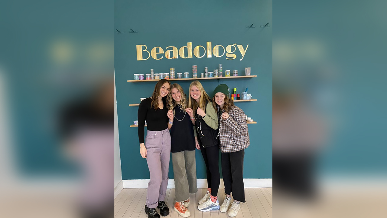 Beadology owner Maysen Minor, left, shows off beaded creations with some of her customers. Experience-based businesses like Beadology, in Provo, are becoming popular in Utah.