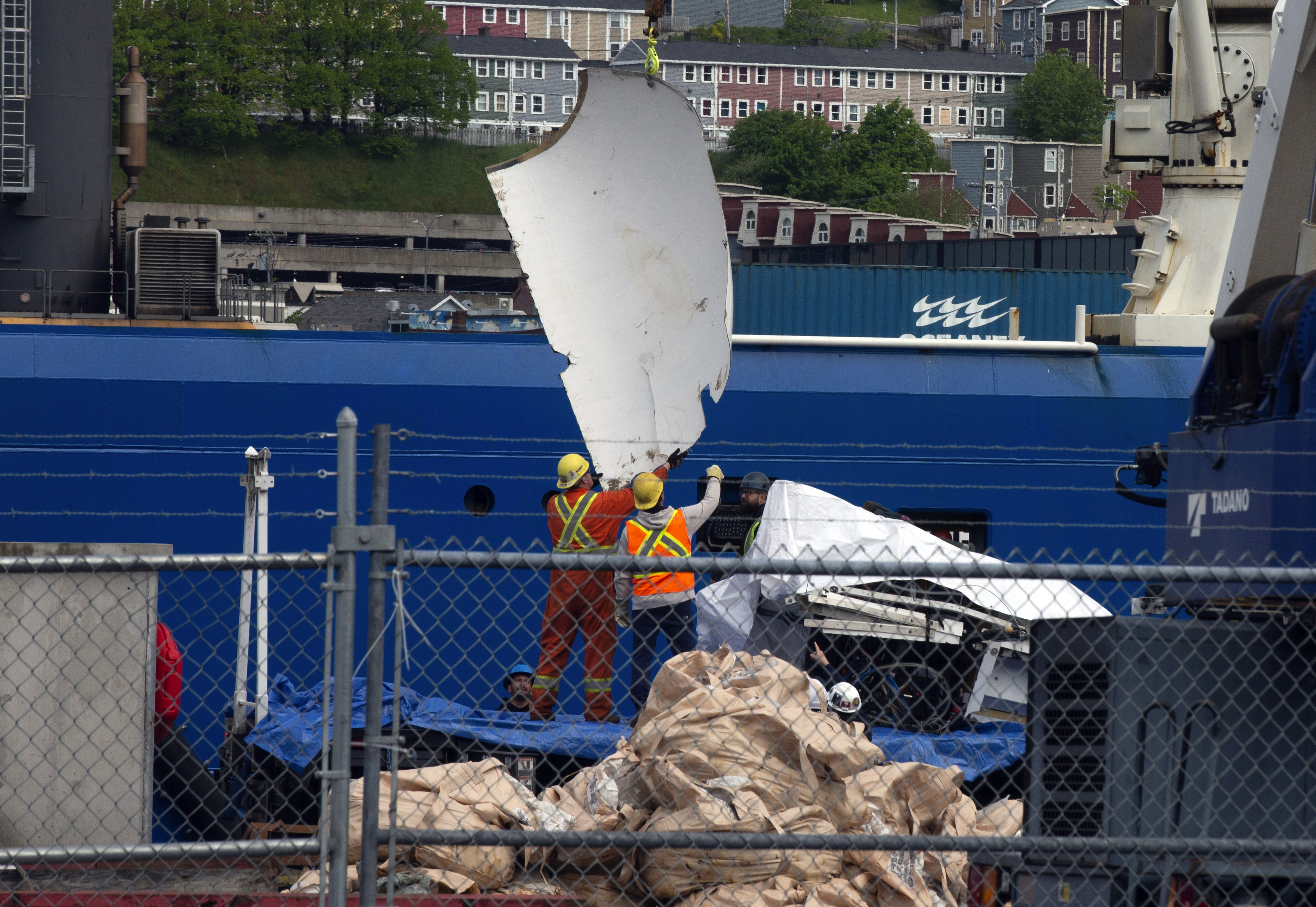 Debris from the Titan submersible, recovered from the ocean floor near the wreck of the Titanic, is unloaded from the ship Horizon Arctic at the Canadian Coast Guard pier in St. John's, Newfoundland, Wednesday.