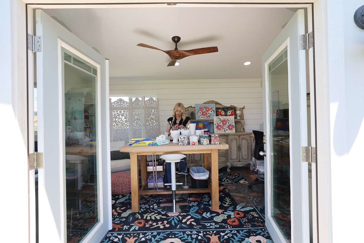 Artist Hannie Clark works in her backyard shed at her home in Pleasant Grove on June 21.