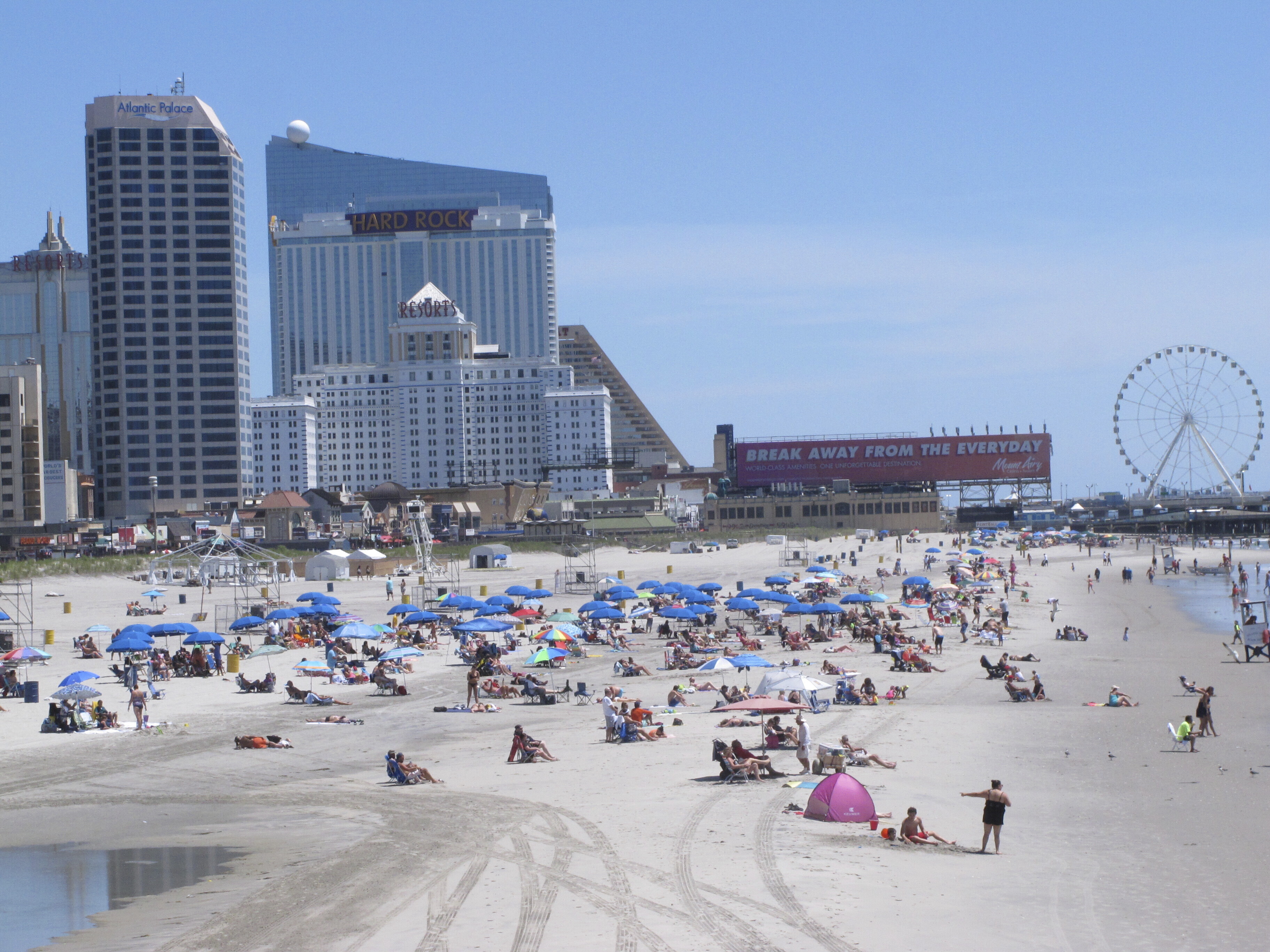 People bask in the sun at the Atlantic City, N.J., beachfront, July 9, 2018. In a move made without public announcement or debate, a state Assembly panel on Tuesday, June 27, 2023, amended a bill that would have extended New Jersey's internet gambling law for another 10 years. shortening that time frame to just two years.