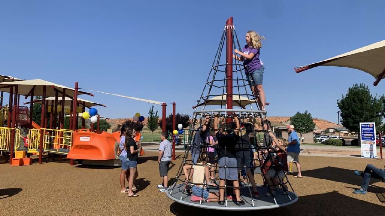 Children play at the All-Abilities Playground at Dixie Springs Park, Hurricane, Friday. Cheers from a crowd soared as the Hurricane Valley Rotary Club opened the new playground.