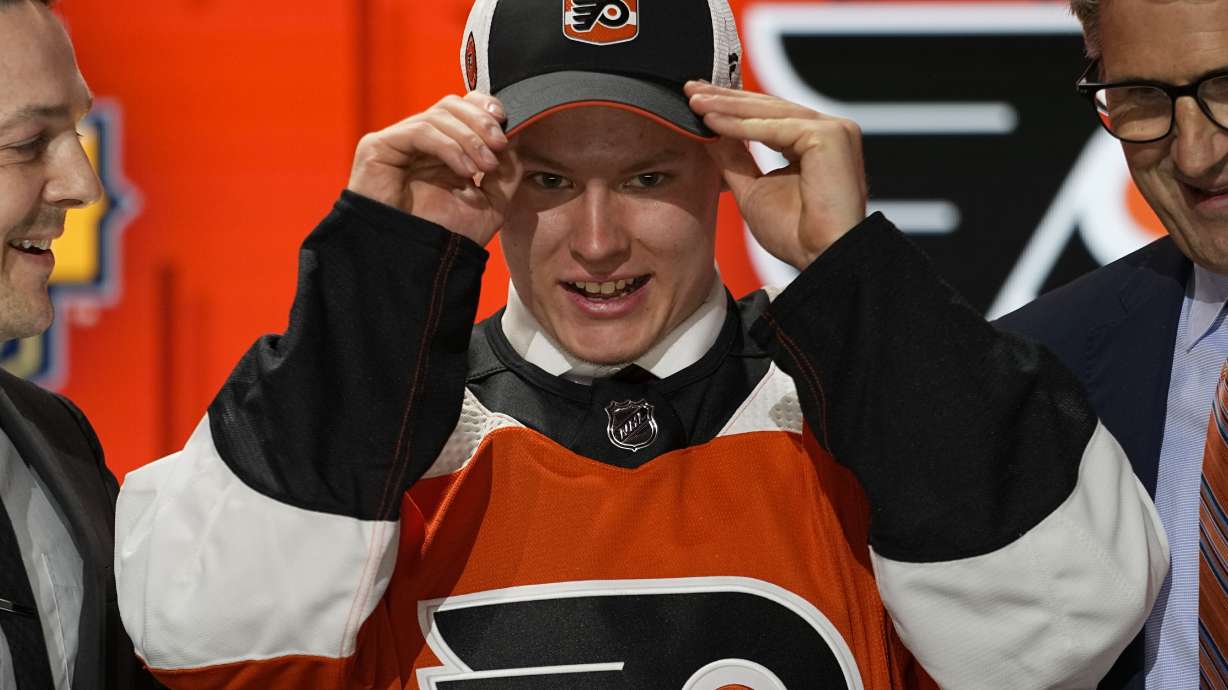 Matvei Michkov adjust his Philadelphia Flyers hat after being picked by the team during the first round of the NHL hockey draft Wednesday, June 28, 2023, in Nashville, Tenn.