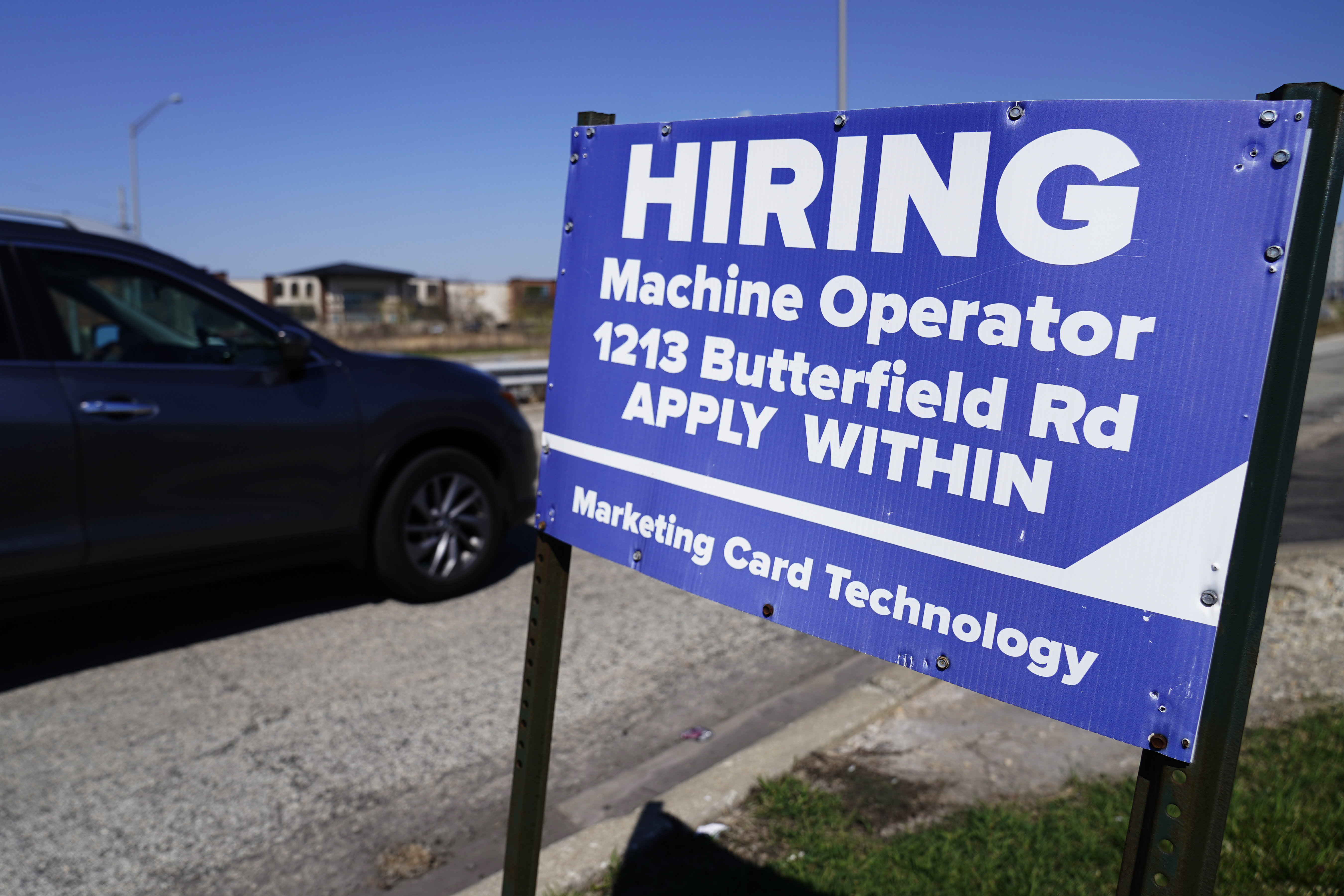 A hiring sign is seen in Downers Grove, Ill., April 12. On Thursday, the Labor Department reports on the number of people who applied for unemployment benefits last week. 