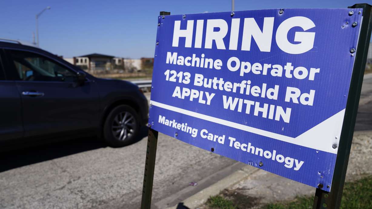 A hiring sign is seen in Downers Grove, Ill., April 12. On Thursday, the Labor Department reports on the number of people who applied for unemployment benefits last week.