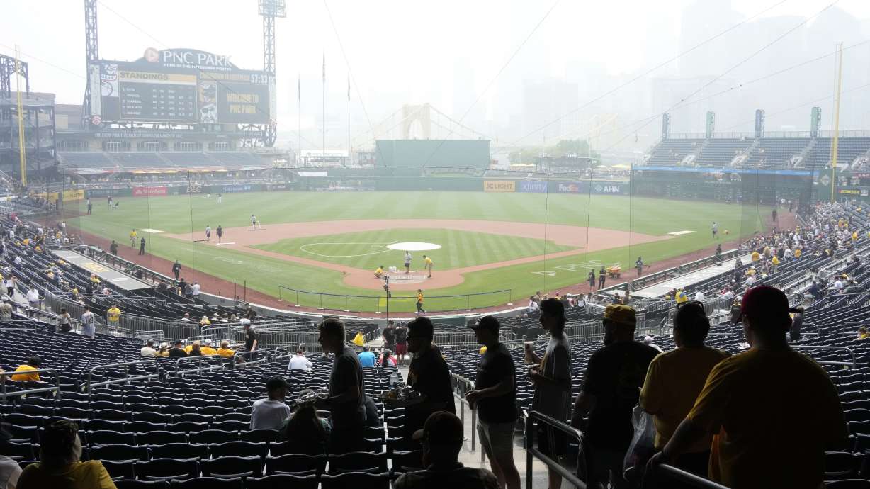 Haze from Canadian wildfires hangs over downtown Pittsburgh and PNC Park as fans take their seats before a baseball game between the Pittsburgh Pirates and the San Diego Padres in Pittsburgh, Thursday, June 29, 2023.