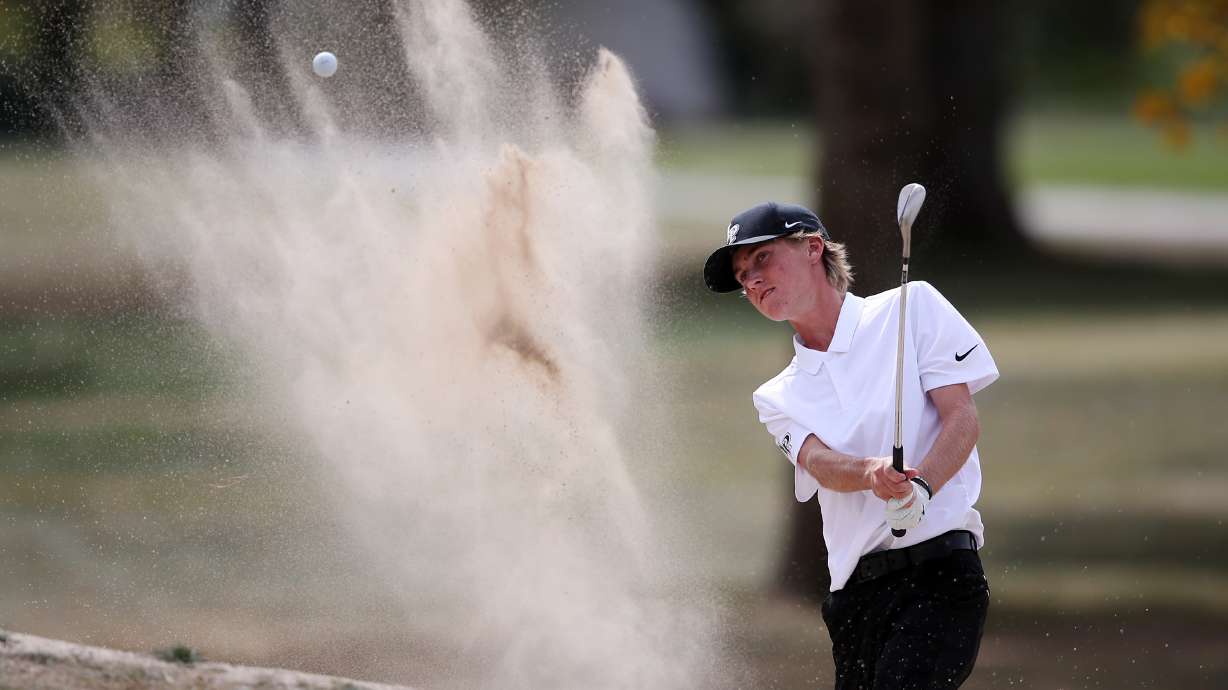 Cooper Jones of Lone Peak hits out of a sand hazard as he competes in the 6A boys state tournament at Davis Park Golf Course in Kaysville on Tuesday, Oct. 5, 2021. Jones finished second.