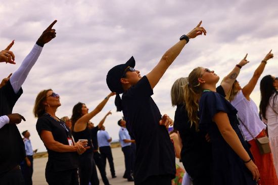 People watch the return of the rocket to the spaceport on the day of Virgin Galactic's rocket plane first commercial flight to the edge of space, at the Spaceport America facility, in Truth or Consequences, New Mexico, Wednesday.