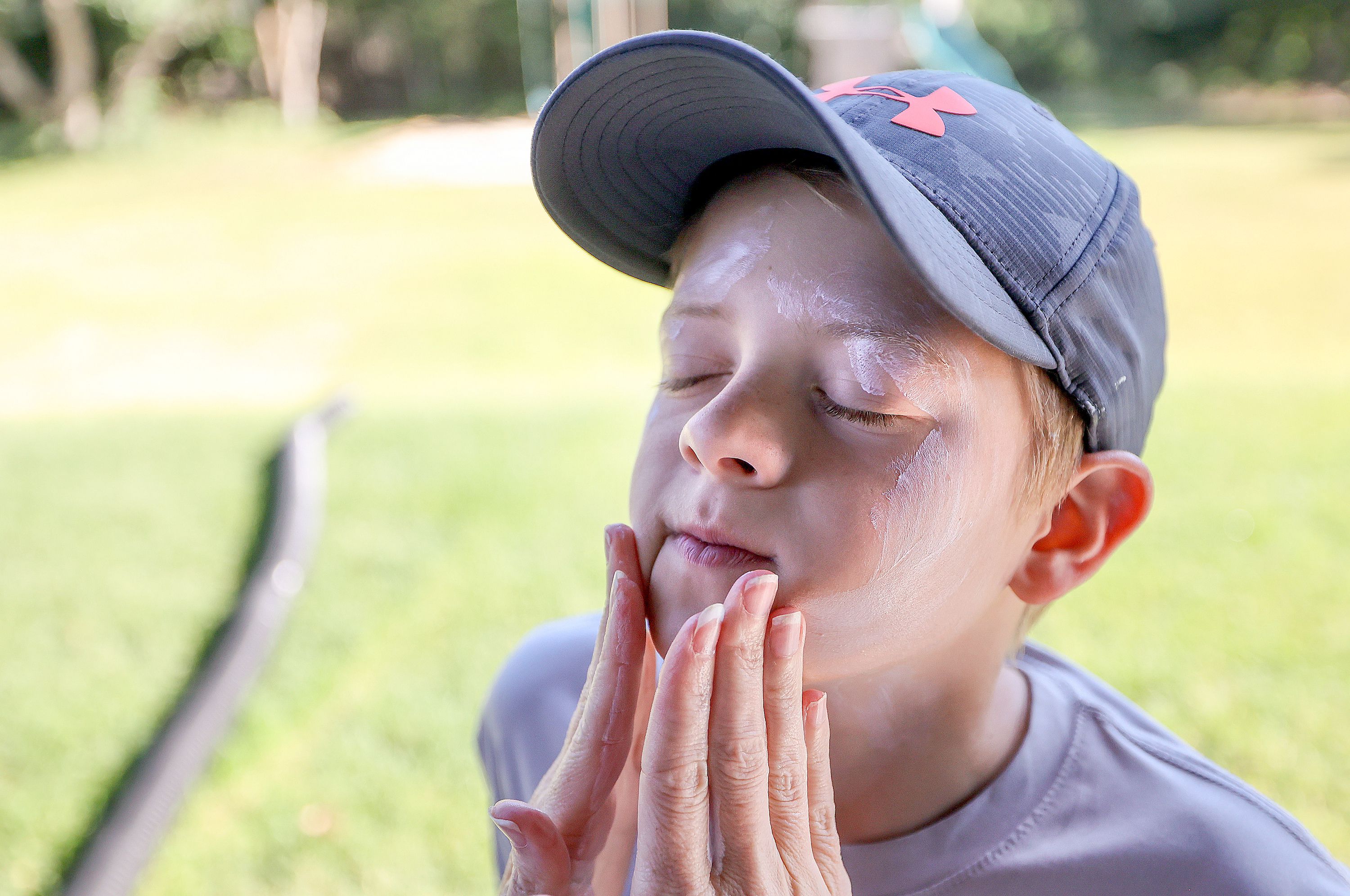 MaryAnn Gerber puts sunscreen on her son Grayson Gerber, 10, at their home in Layton on Tuesday. MaryAnn Gerber had melanoma at age 23.