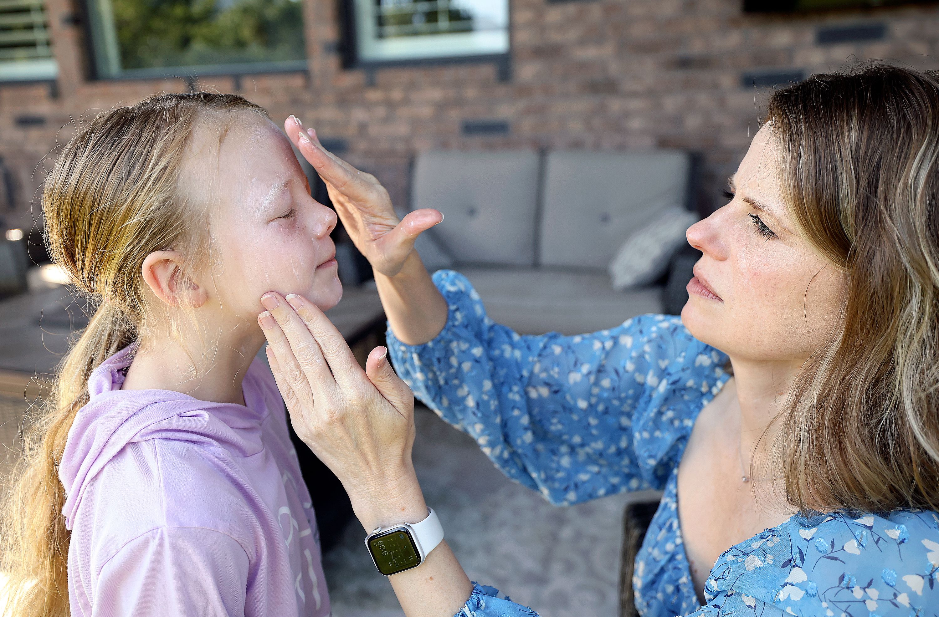 MaryAnn Gerber puts sunscreen on her daughter Maggie Gerber, 8, at their home in Layton on Tuesday. MaryAnn Geber had melanoma at age 23.