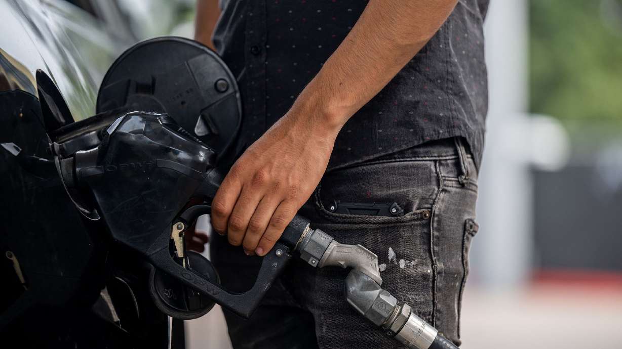 A person pumps gas on May 26 in Austin, Texas. Drivers can expect much cheaper gas prices than last year.