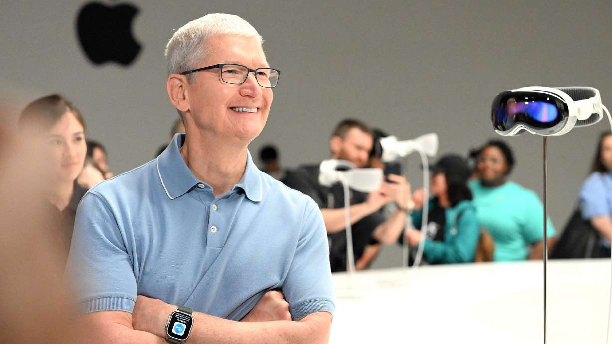Apple CEO Tim Cook speaks with members of the media next to Apple's new Vision Pro virtual reality headset, during Apple's Worldwide Developers Conference at the Apple Park campus in Cupertino, Calif., on June 5.