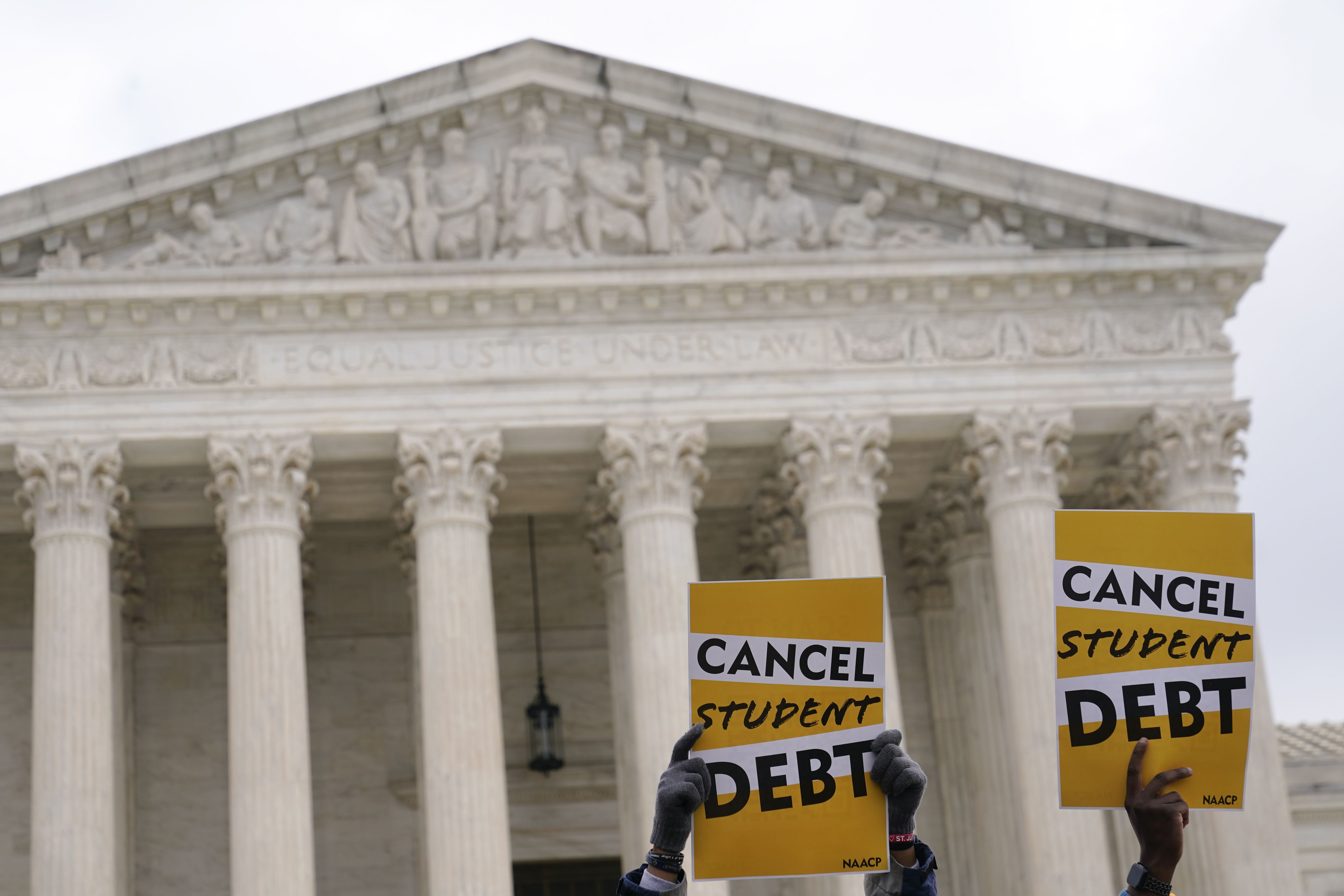 Student debt relief advocates gather outside the Supreme Court on Capitol Hill in Washington, Feb. 28, as the court hears arguments over President Joe Biden’s student debt relief plan.