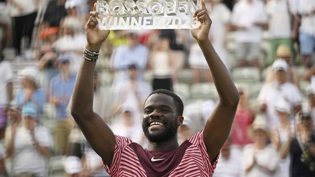 United States' Frances Tiafoe holds up the trophy after winning the final match of the Stuttgart Open against Germany's Jan-Lennard Struff, in Stuttgart, Germany, Sunday, June 18, 2023. Tiafoe won 4-6, 7-6 (1), 7-6 (8).