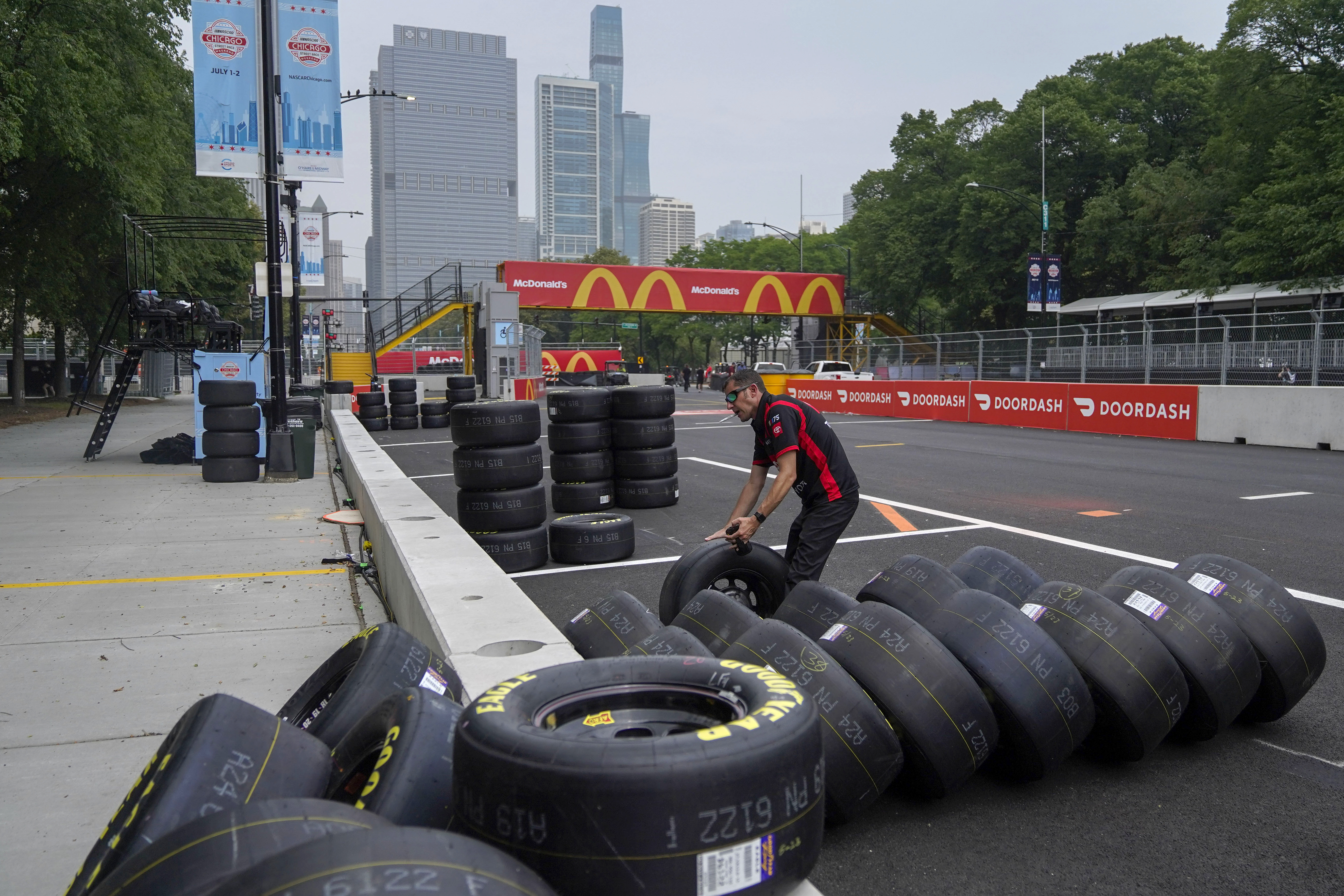Joe Gibbs racing crew member John Ianham checks tires as preparation for the inaugural NASCAR Chicago Street Race Weekend continues Friday, June 30, 2023, in downtown Chicago. 