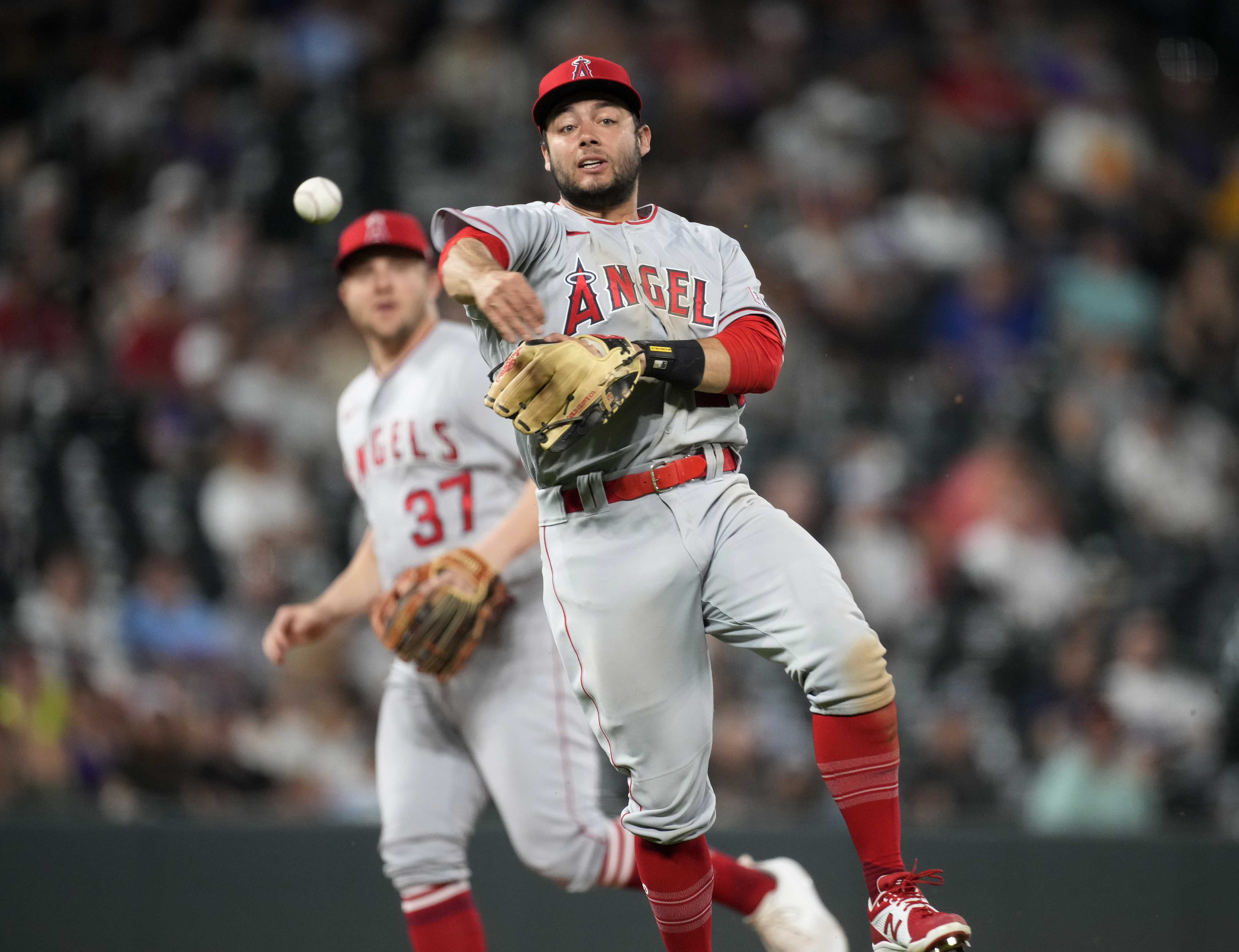 Los Angeles Angels shortstop David Fletcher throws to first base for the out on Colorado Rockies' Jorge Alfaro, ending the eighth inning of a baseball game Saturday, June 24, 2023, in Denver.