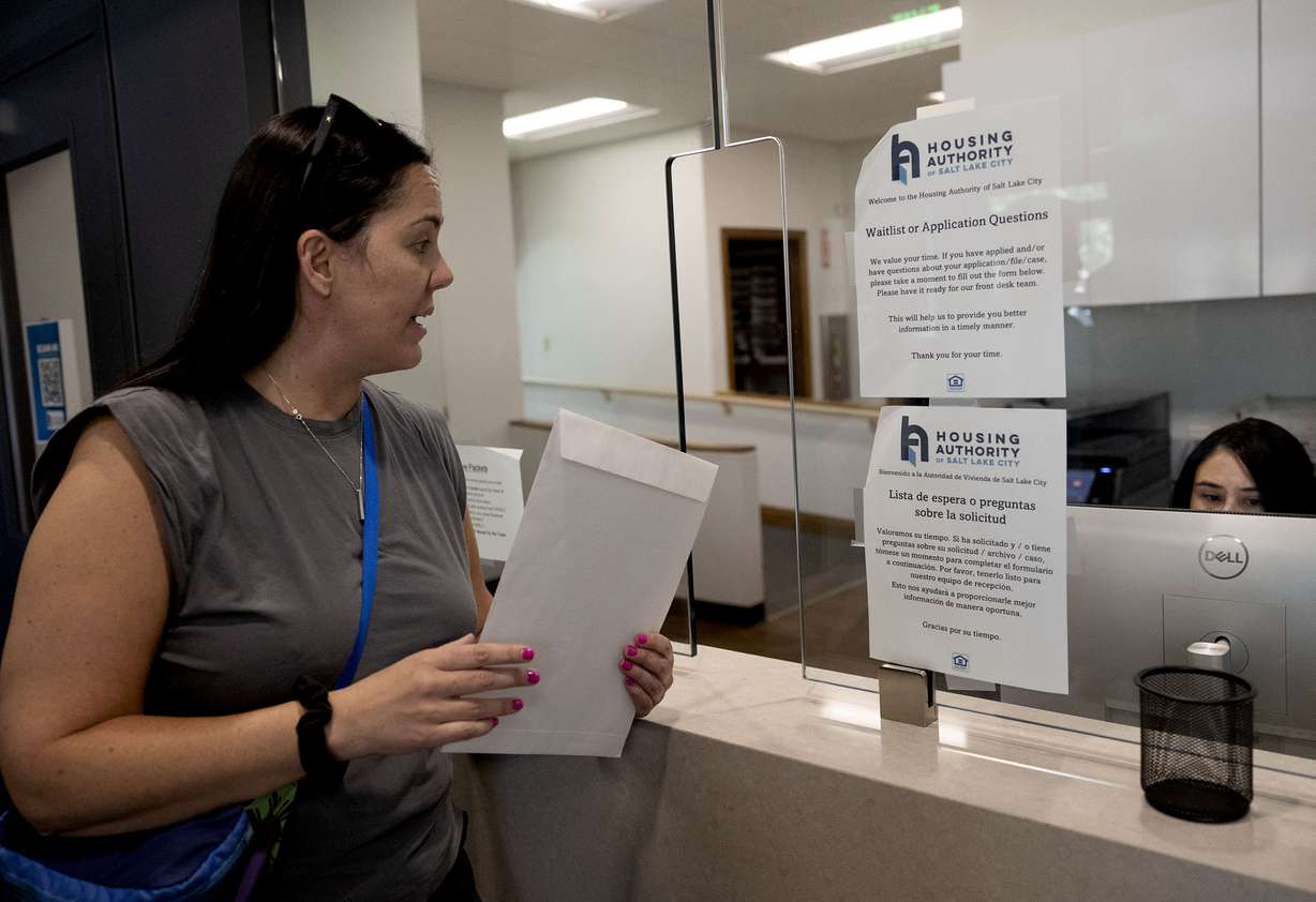 Sara Price delivers a collective letter to the president of her apartment complex demanding an end to the rent increase and the opportunity to negotiate collectively for a fair lease at the office of the Housing Authority of Salt Lake City on Friday.