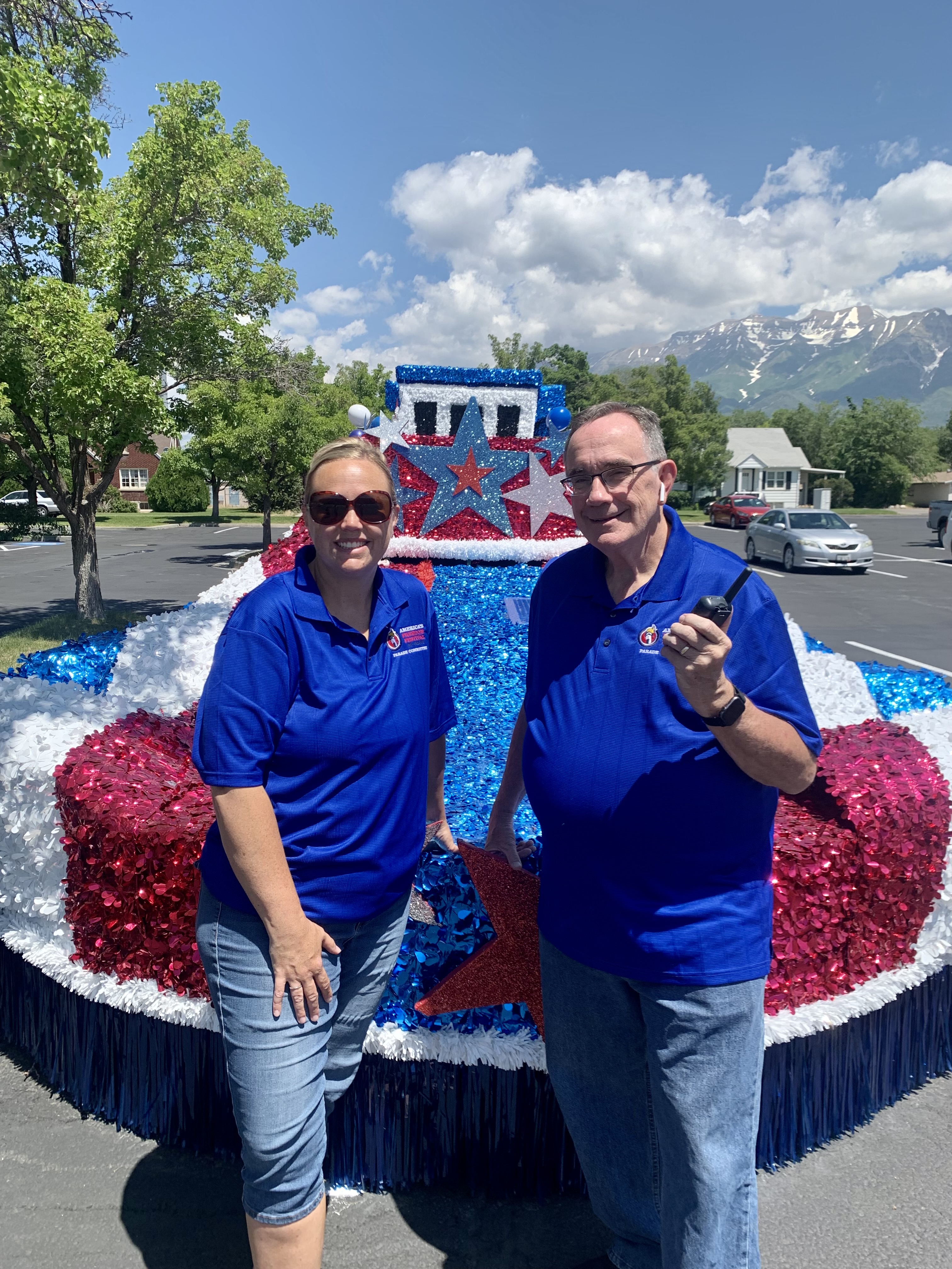 Tara Catmull and her dad Terry Kennard pose in front of a float at the Freedom Festival in 2022. The two of them have volunteered for the Freedom Festival Grand Parade for almost 20 years.