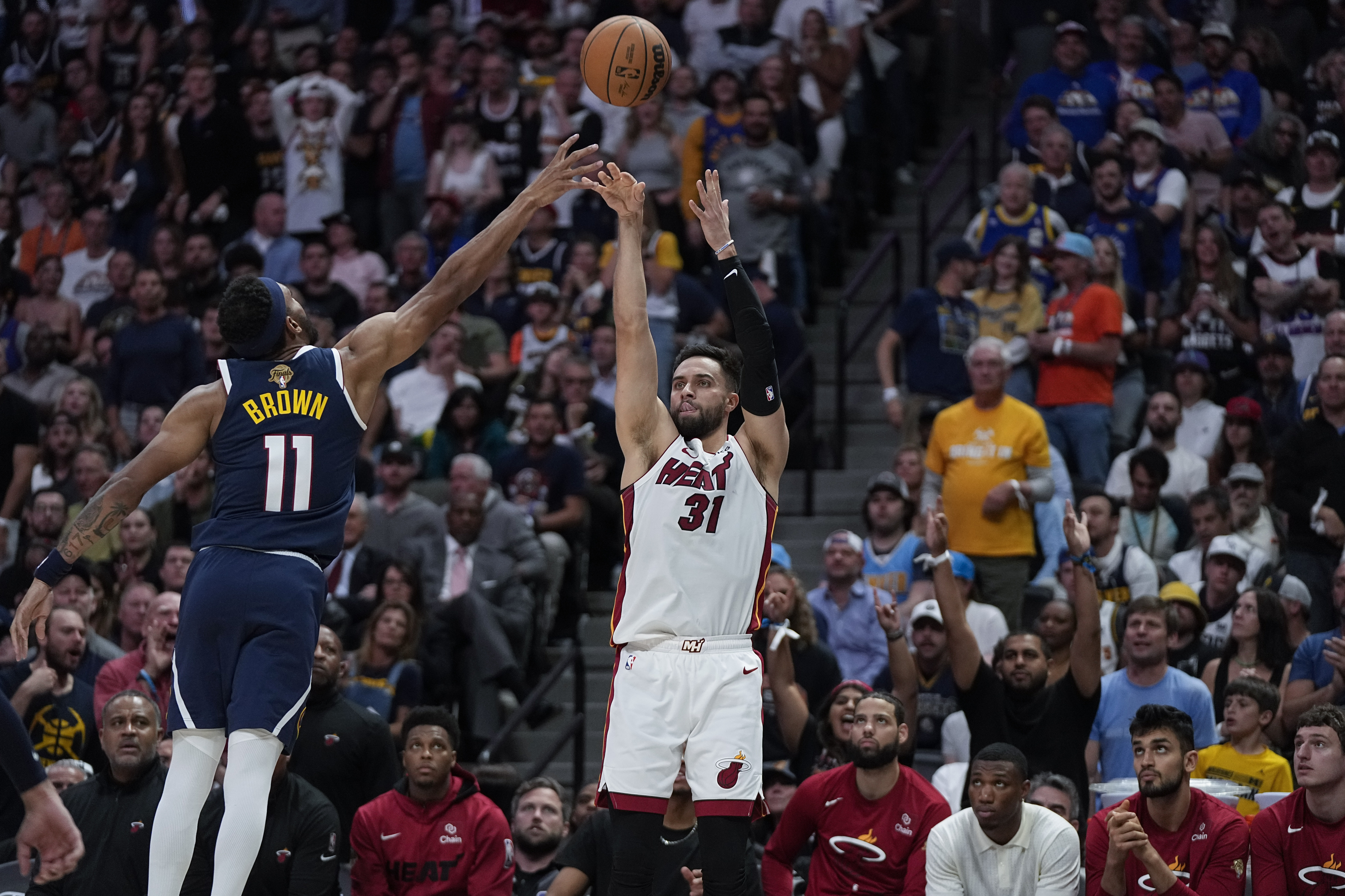 Miami Heat guard Max Strus (31) shoots over Denver Nuggets forward Bruce Brown, left, during the first half of Game 2 of basketball's NBA Finals, Sunday, June 4, 2023, in Denver. 