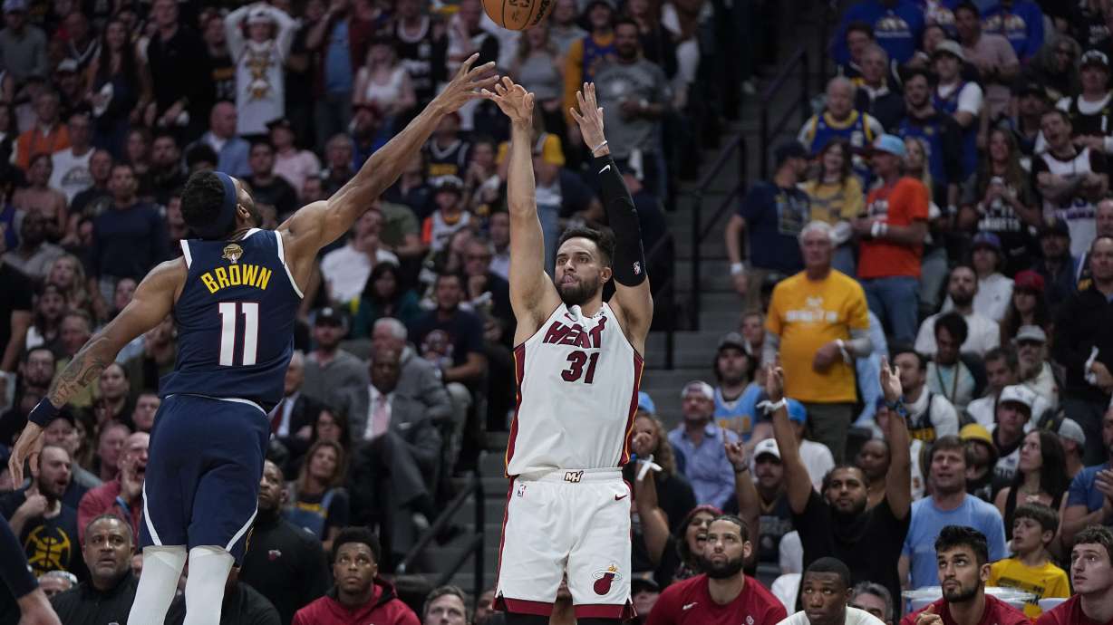 Miami Heat guard Max Strus (31) shoots over Denver Nuggets forward Bruce Brown, left, during the first half of Game 2 of basketball's NBA Finals, Sunday, June 4, 2023, in Denver.