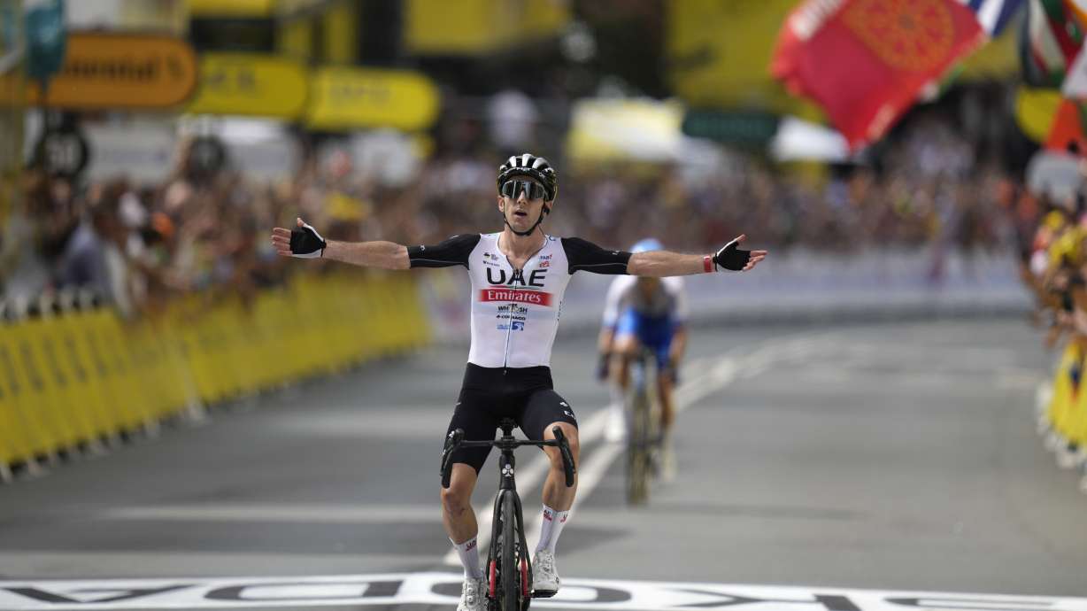 Britain's Adam Yates celebrates after crossing the finish line of the first stage of the Tour de France cycling race over 182 kilometers (113 miles) with start and finish in Bilbao, Spain, Saturday, July 1, 2023.
