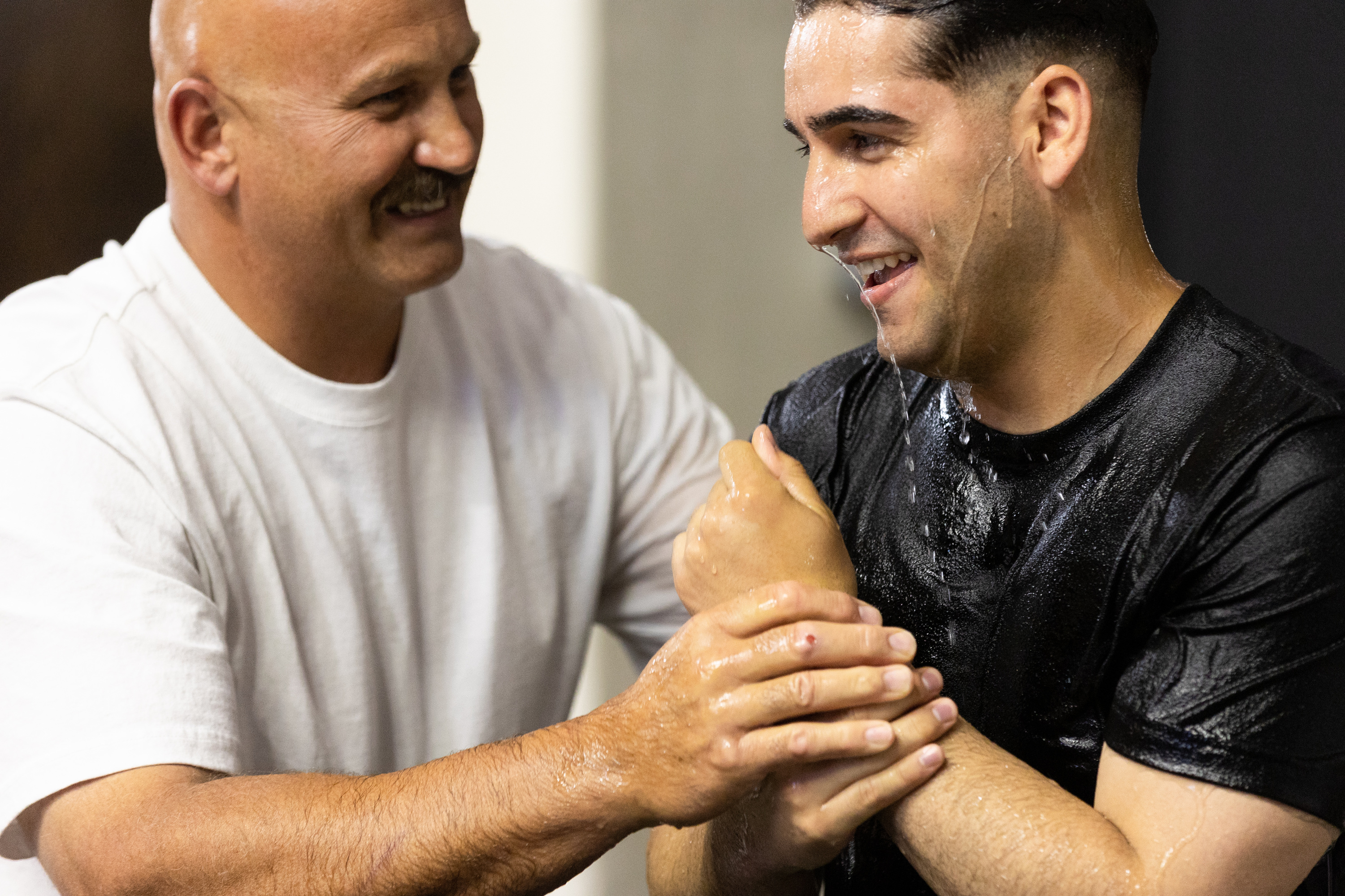 Mike Myers baptizes Elijah Lopez at the 2023 Convention of Jehovah’s Witnesses at the Dee Events Center in Ogden on Saturday. After a three-year pandemic pause, Jehovah’s Witnesses have resumed hosting public conventions worldwide.
