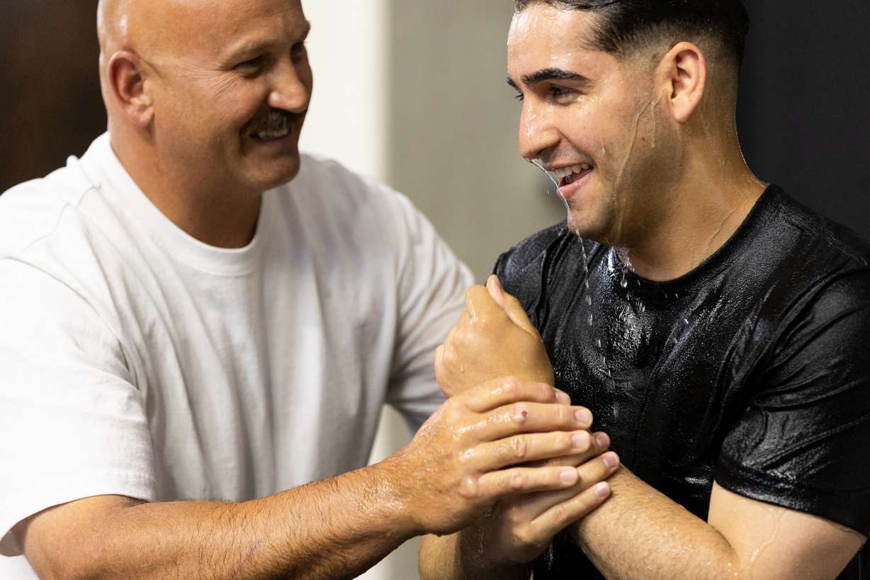 Mike Myers baptizes Elijah Lopez at the 2023 Convention of Jehovah’s Witnesses at the Dee Events Center in Ogden on Saturday. After a three-year pandemic pause, Jehovah’s Witnesses have resumed hosting public conventions worldwide.