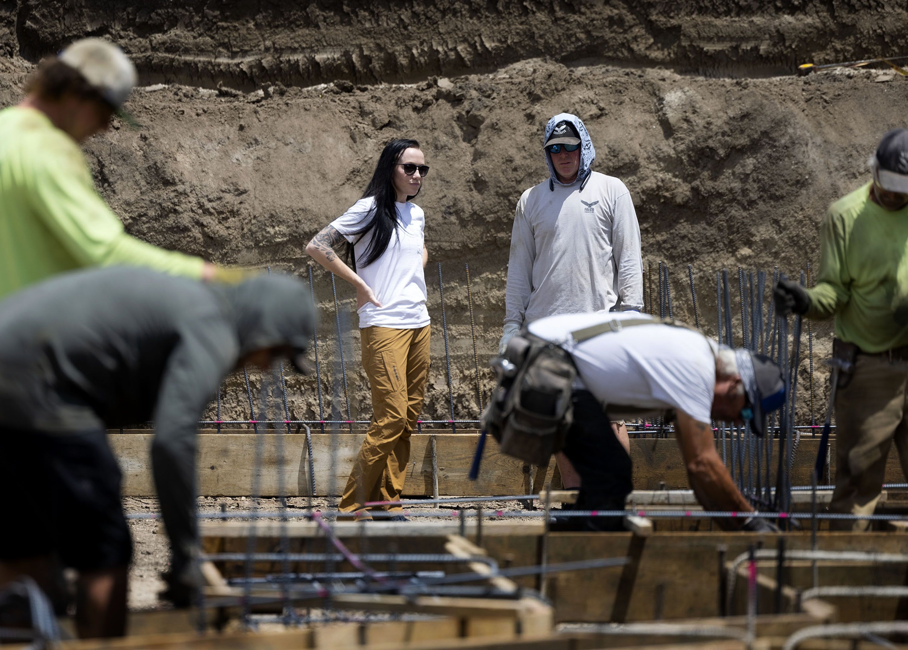 Stephanie Dailey speaks with Falco Concrete’s Branden Andrews in Draper on Thursday. A new report shows men perceive less gender bias in the workplace than do women. 