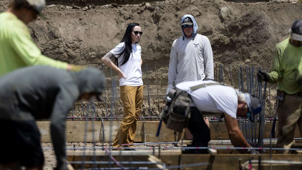 Stephanie Dailey speaks with Falco Concrete’s Branden Andrews in Draper on Thursday. A new report shows men perceive less gender bias in the workplace than do women.