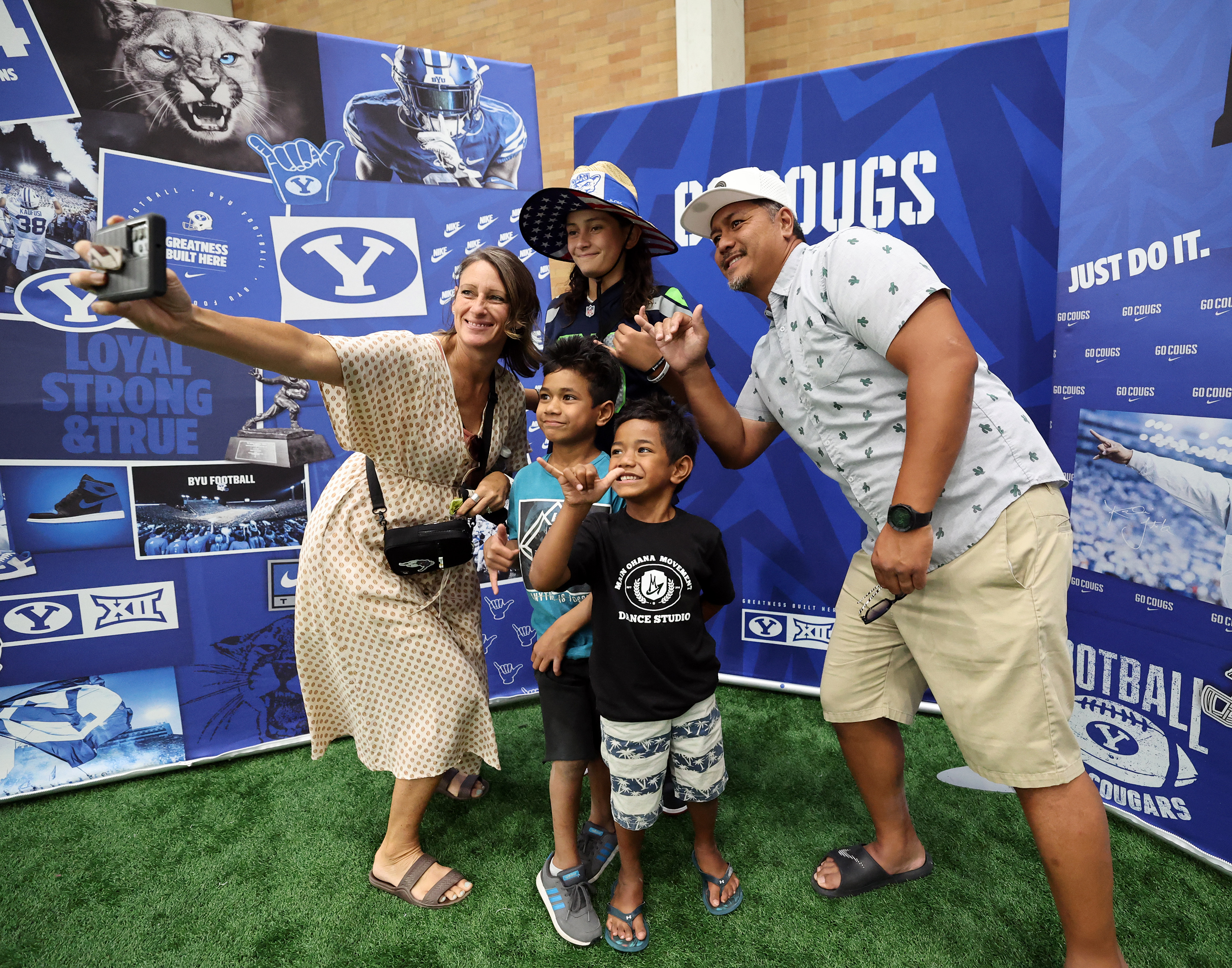 The Fanene family from St. George takes a selfie in the Indoor Practice Facility as BYU holds a party to celebrate their move into the Big 12 Conference with music, games and sports exhibits in Provo on Saturday, July 1, 2023.