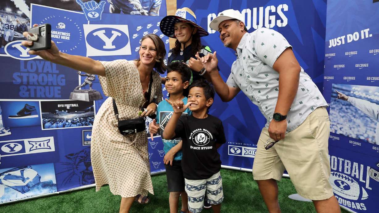 The Fanene family from St. George takes a selfie in the Indoor Practice Facility as BYU holds a party to celebrate their move into the Big 12 Conference with music, games and sports exhibits in Provo on Saturday, July 1, 2023.