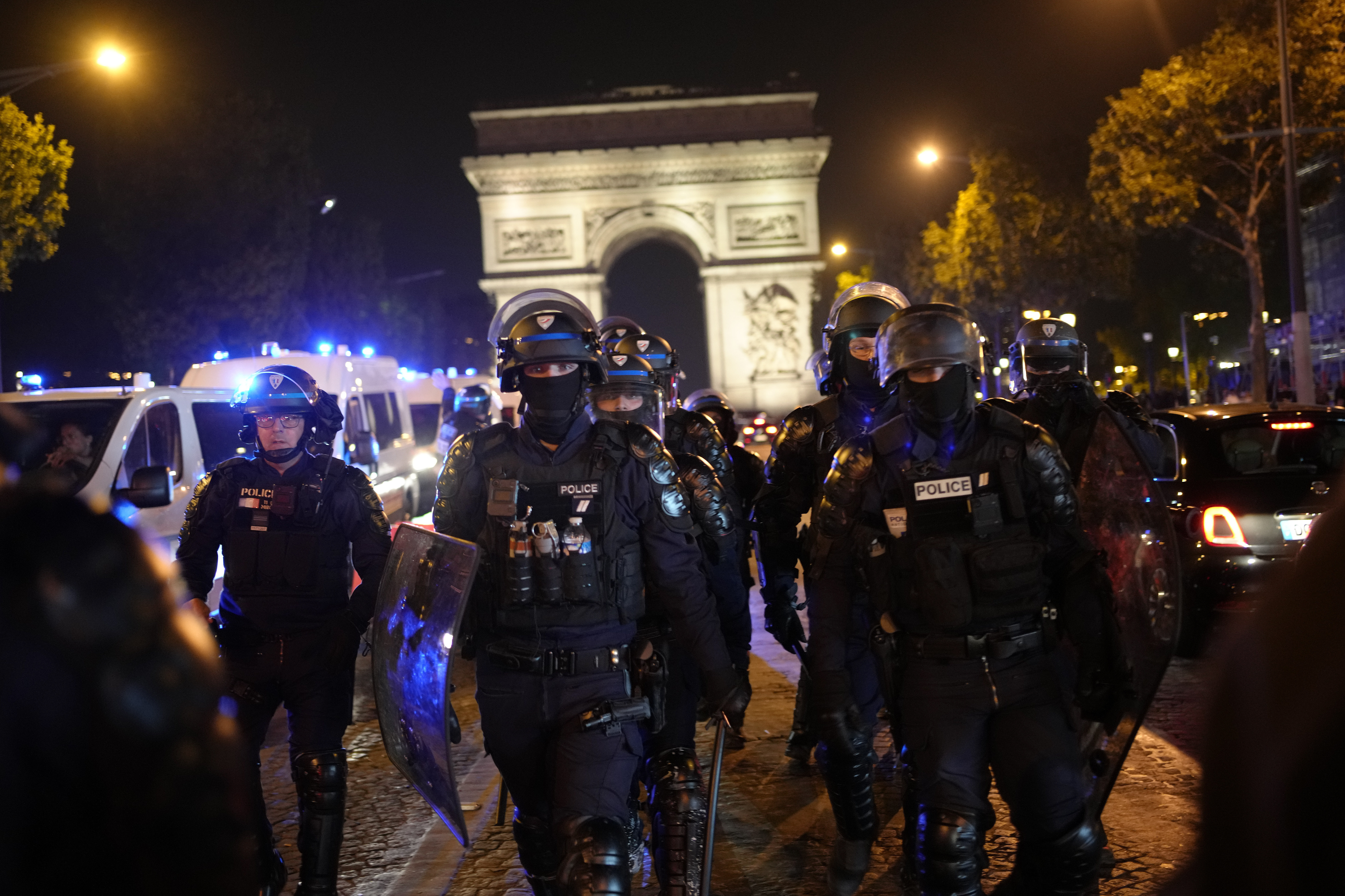 Police officers patrol in front of the Arc de Triomphe on the Champs Elysees in Paris, Saturday. The grandmother of 17-year-old Nahel Merzouk told BFM TV she was angry at the officer who killed her grandson but not at the police in general. 