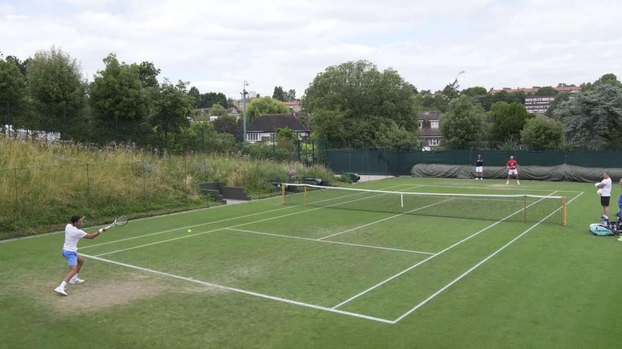 Novak Djokovic of Serbia, left, takes part in a practice session ahead of the Wimbledon tennis championships at Wimbledon, in London, Sunday, July 2, 2023. The Wimbledon Tennis championships start on July 3.