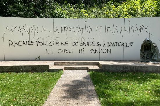 Graffiti reading "Police scum from Saint-Soline to Nanterre — do not forget or forgive" on a monument commemorating Holocaust victims and members of the French resistance memorial, Sunday in Paris suburb Nanterre.