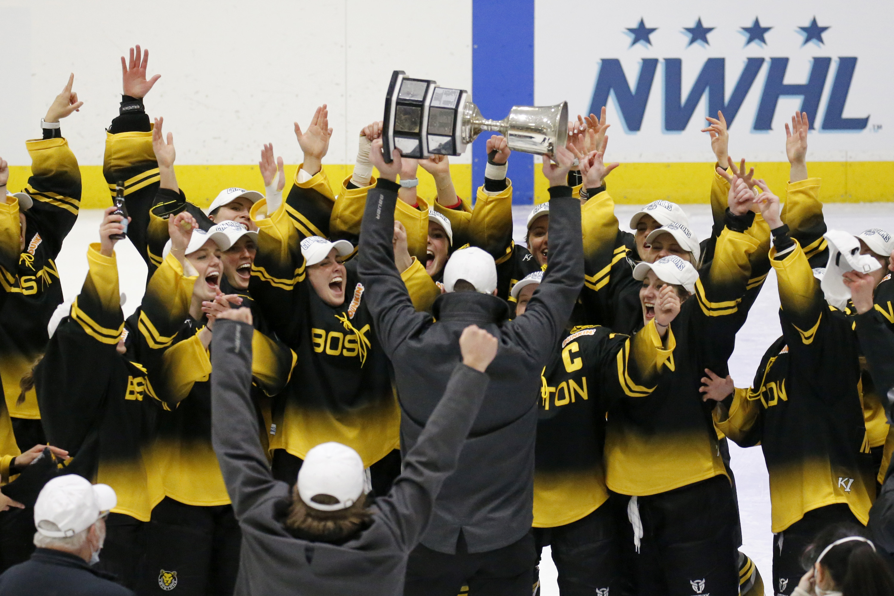 FILE - Boston Pride players cheer as coach Paul Mara hoists the NWHL Isobel Cup trophy after the team's win over the Minnesota Whitecaps in the championship hockey game in Boston, Saturday, March 27, 2021. Organizers announced plans Friday, June 30, 2023, to launch a new women’s professional hockey league in January that they hope will provide a stable, economically sustainable home for the sport's top players for years to come. The agreement ends a long standoff between the seven-team Professional Hockey Federation (PHF) and the PWHPA. 