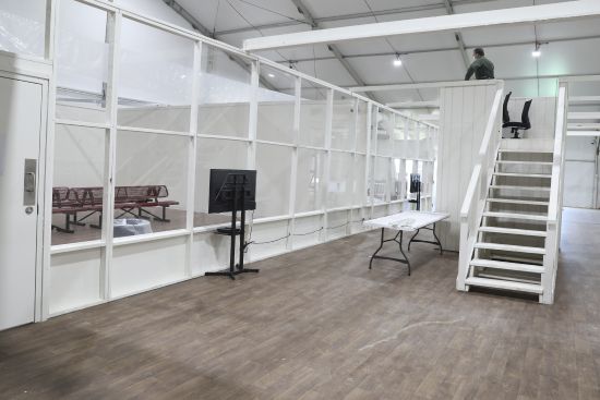 An interior view of the soft-sided migrant processing facility is seen in Laredo, Texas, on Sept. 23, 2021. As the Biden administration prepared to launch speedy asylum screenings at the border in April, authorities pledged a key difference from a Trump-era version of the policy: Migrants would be guaranteed access to legal representation. Nearly three months and thousands of screenings later, the promise of attorney access appears unfulfilled.