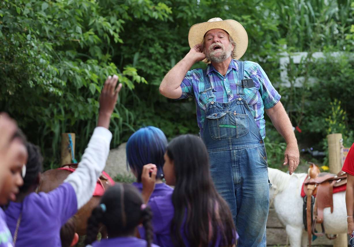 Gil Ma, the director of the farm at Gardner Village in West Jordan, talks with a school group that has come to tour the farm on June 20.