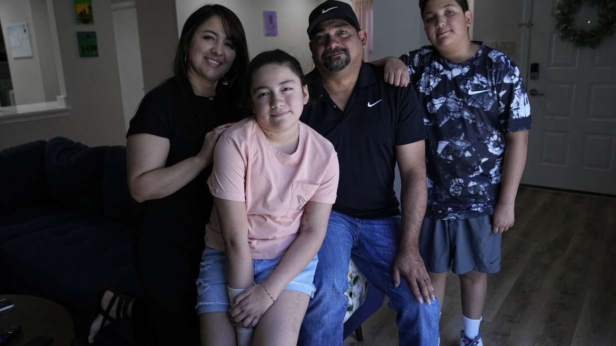 Mayah Zamora, second from left, a survivor of the mass shooting at Robb Elementary in Uvalde, Texas, poses for a photo with her mom Christina, left, dad Ruben, and brother Zach, right, at their home in San Antonio, June 27.