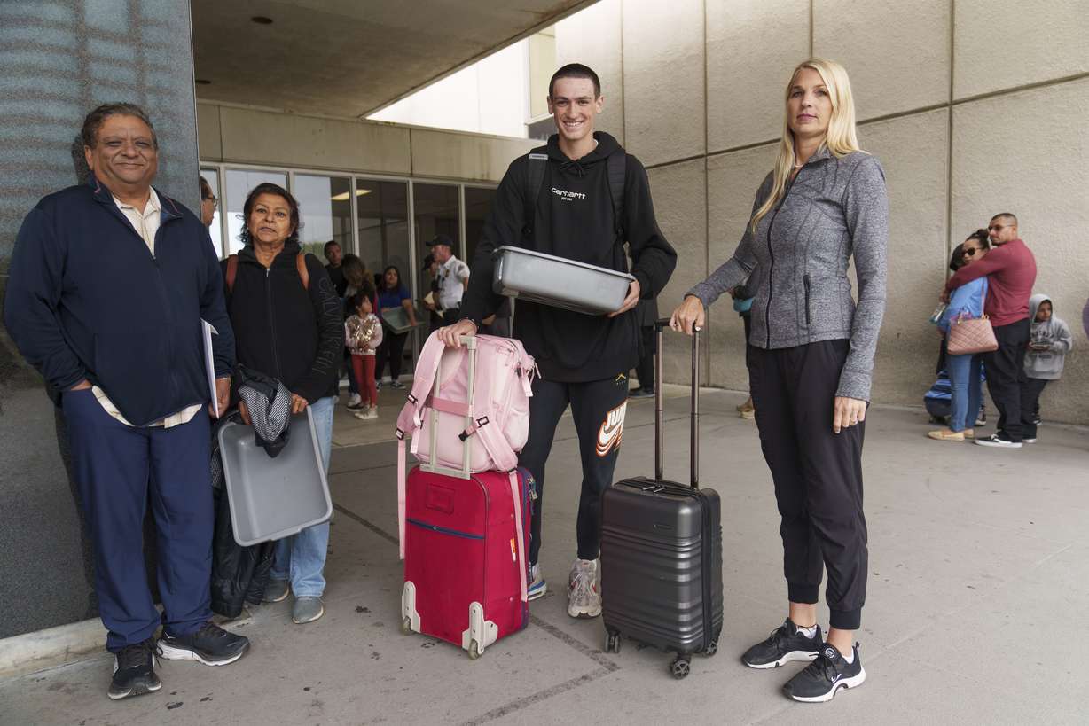 Marni Larsen and her son, Damon Rasmussen of Holladay, Utah, stand in line hoping to get her son's passport outside the Los Angeles Passport Agency at the Federal Building in Los Angeles on June 14. Larsen applied for her son's passport two months earlier and spent weeks checking for updates online or through a frustrating call system.