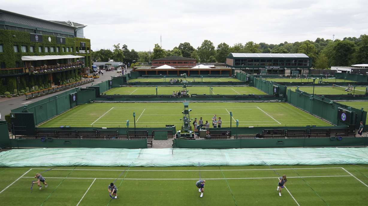Ground staff practice moving the covers on the outside courts at the All England Lawn Tennis and Croquet Club in Wimbledon, London, Britain, ahead of the championships starting tomorrow, on Sunday, July 2, 2023.
