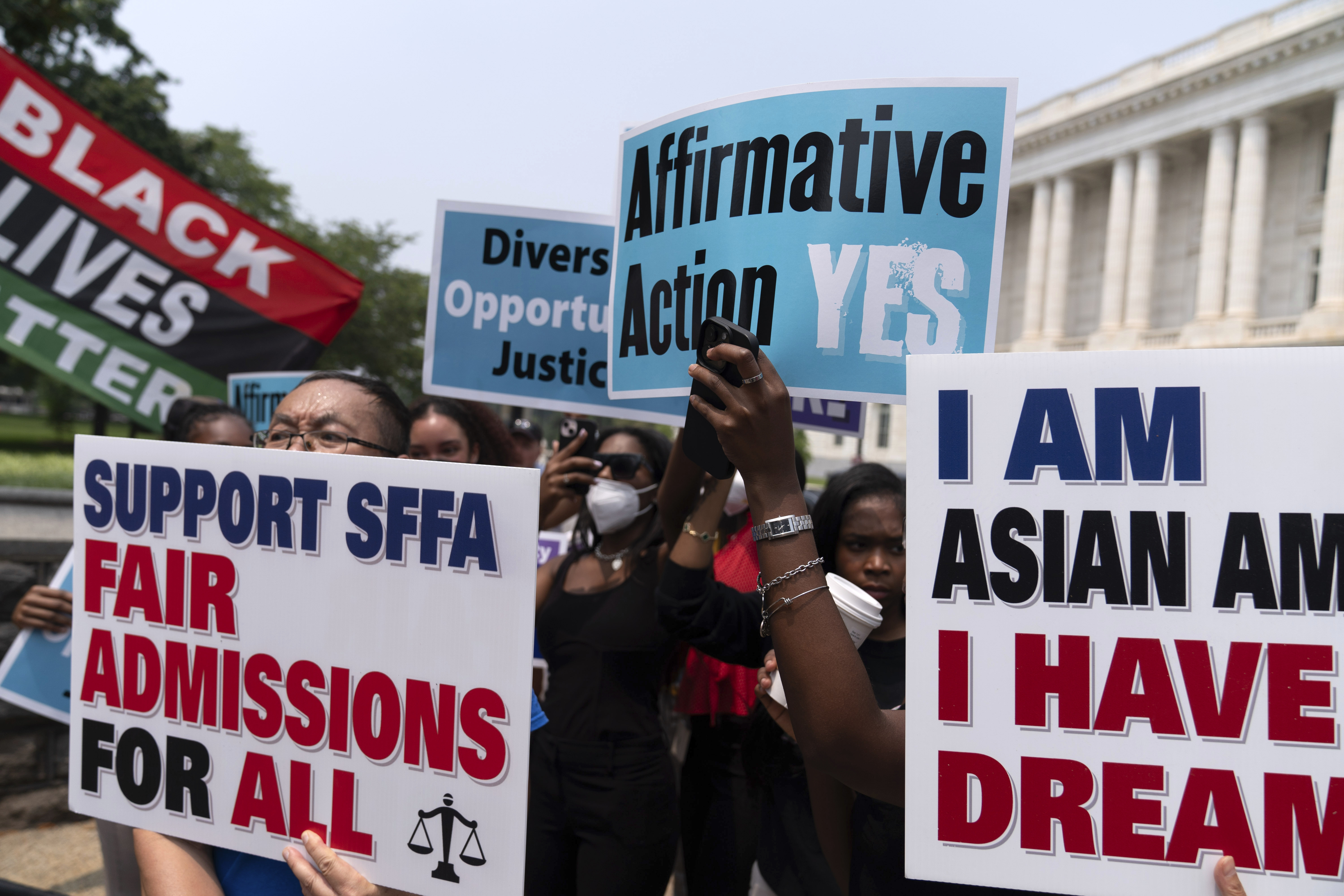 Demonstrators protest outside of the Supreme Court in Washington, Thursday after the court struck down affirmative action in college admissions. Activists say they will sue Harvard over its use of legacy preferences for children of alumni.