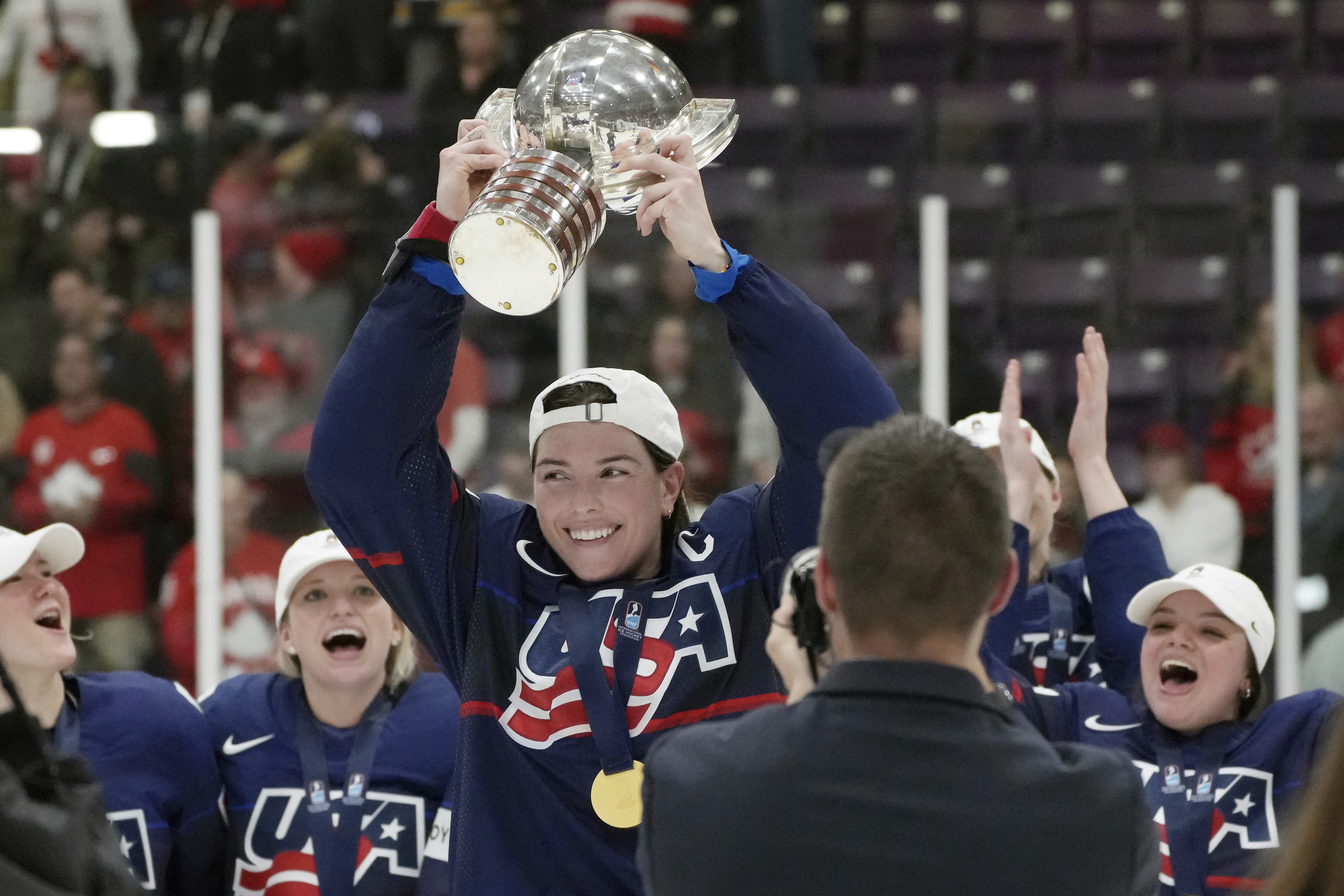 FILE - United States forward Hilary Knight, center, holds the cup as she celebrates with teammates after defeating Canada in the gold medal game at the women's world hockey championships in Brampton, Ontario, April 16, 2023. Patience remains the operative word from United States star Knight on the Professional Women’s Hockey Players’ Association’s long-awaited bid to launch its own pro league.