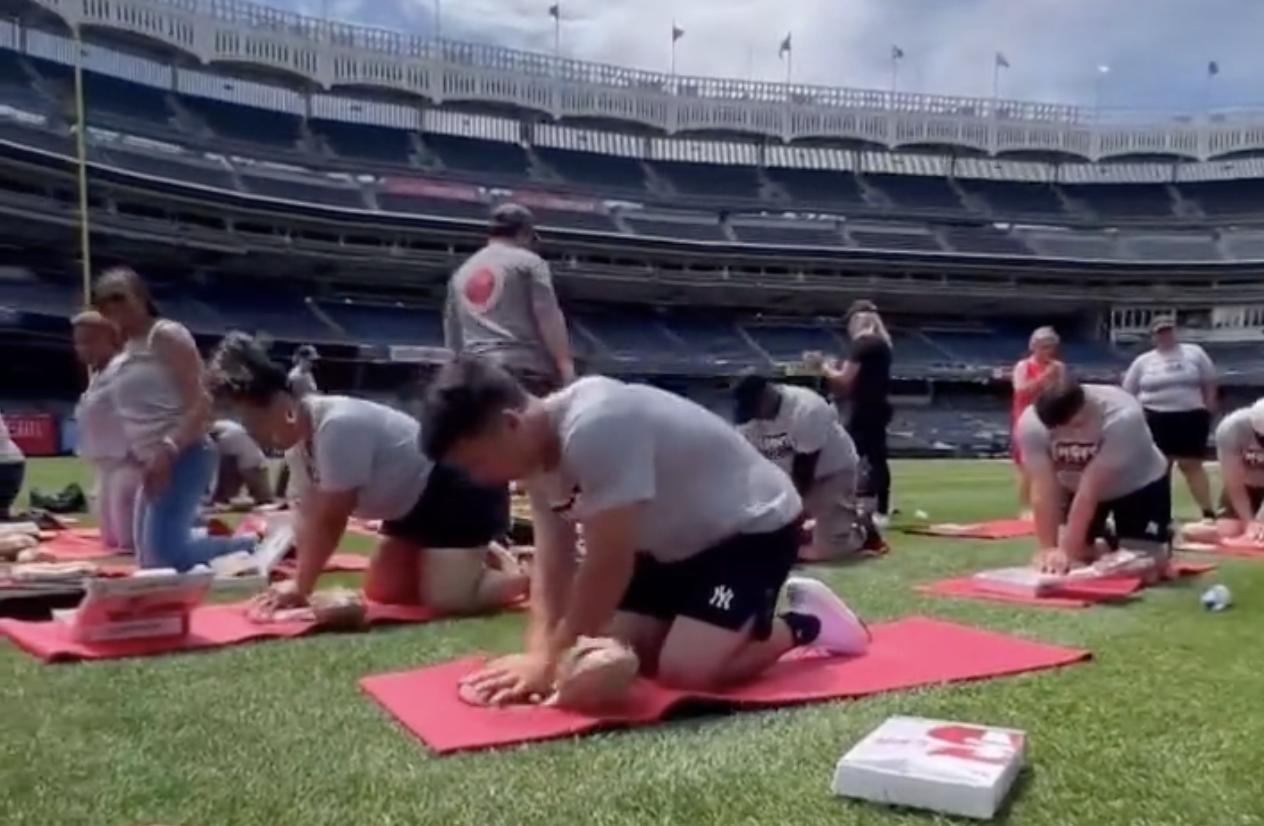New York Yankees shortstop Anthony Volpe performs CPR on a dummy during a training session.