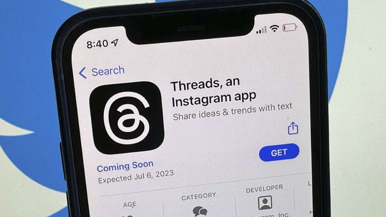 The announcement of the social media app 'Threads' is displayed in Apple's U.S. App Store seen on the screen of a smartphone in Berlin, Germany, on Tuesday. Meta is poised to launch a new app that appears to mimic Twitter in a direct challenge to the social media platform owned by billionaire Elon Musk.