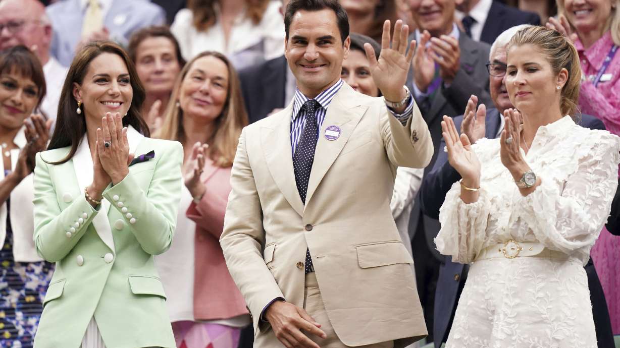 Britain's Kate, Princess of Wales, left, stands in the royal box with tennis champion Roger Federer and his wife Mirka, on day two of the Wimbledon tennis championships in London, Tuesday, July 4, 2023.