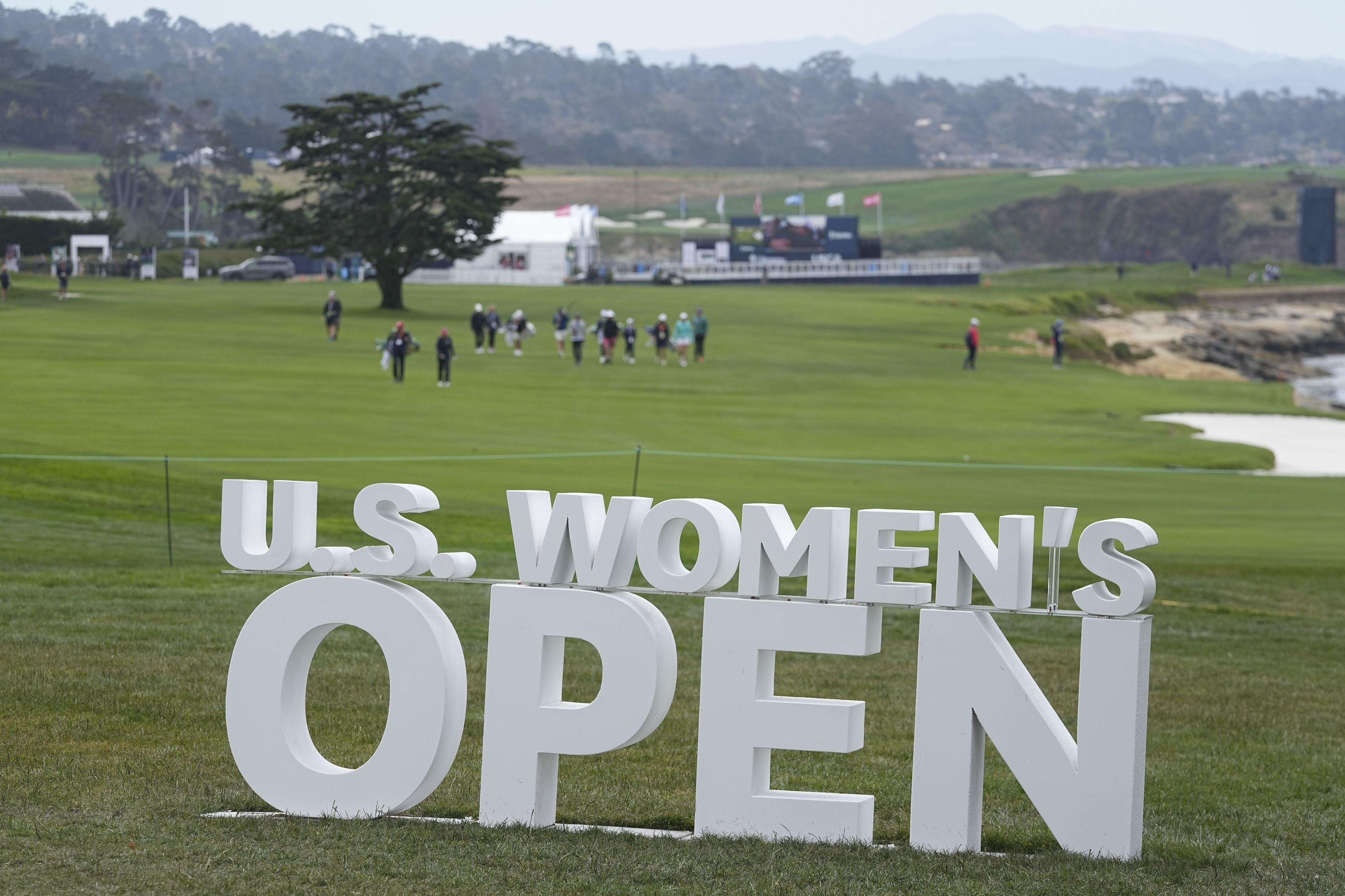 Golfers walks down the 18th fairway during a practice round for the U.S. Women's Open golf tournament at the Pebble Beach Golf Links, Tuesday, July 4, 2023, in Pebble Beach, Calif. 