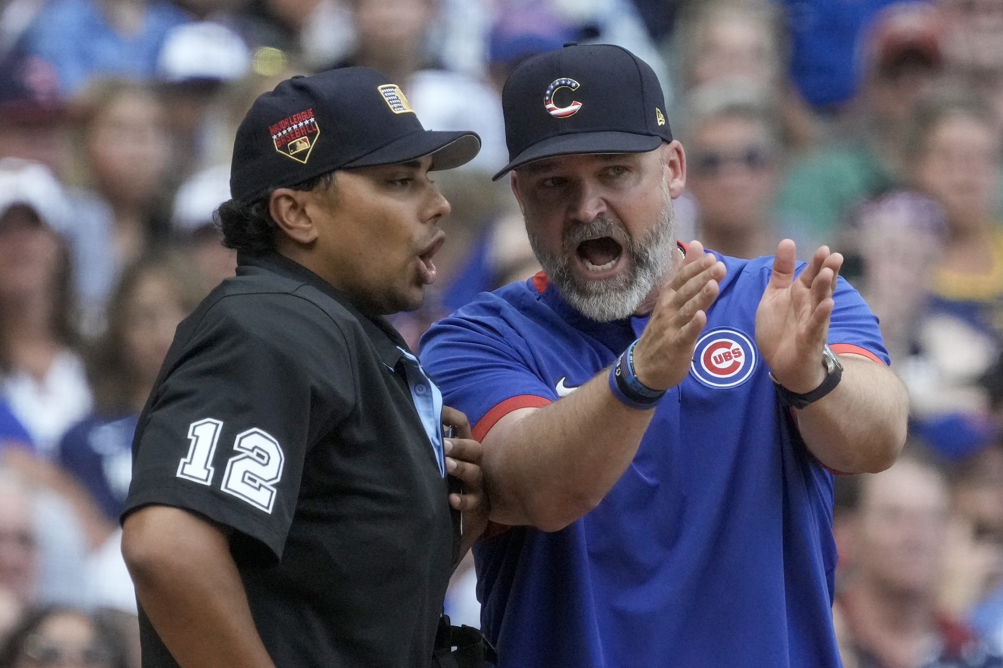 CORRECTS UMPIRE TO ERICH BACCHUS, INSTEAD OF GERRY DAVIS - Chicago Cubs manager David Ross argues with home plate umpire Erich Bacchus during the sixth inning of a baseball game against the Milwaukee Brewers Tuesday, July 4, 2023, in Milwaukee.
