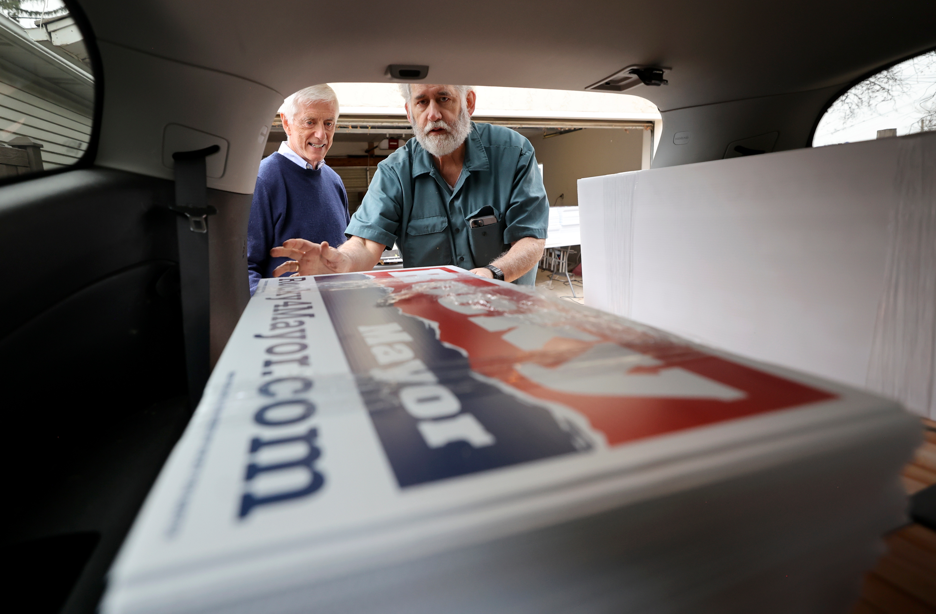 Former Salt Lake City Mayor Rocky Anderson and Jay Magure, former chief of staff for Anderson and former president of the Salt Lake firefighters' union, load “Rocky 4 Mayor” yard signs into a vehicle at Anderson’s home in Salt Lake City on April 25.